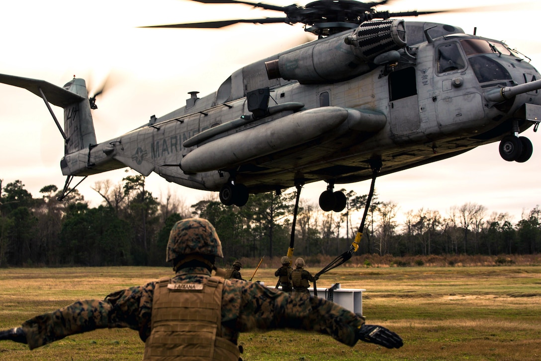 Marines conduct external lifts on Camp Lejeune, N.C., Jan. 6, 2016. The Marines, assigned to Combat Logistics Battalion 2, were responsible for directing the aircraft from the ground and attaching a load with help from a crew chief. U.S. Marine Corps photo by Lance Cpl. Erick Galera