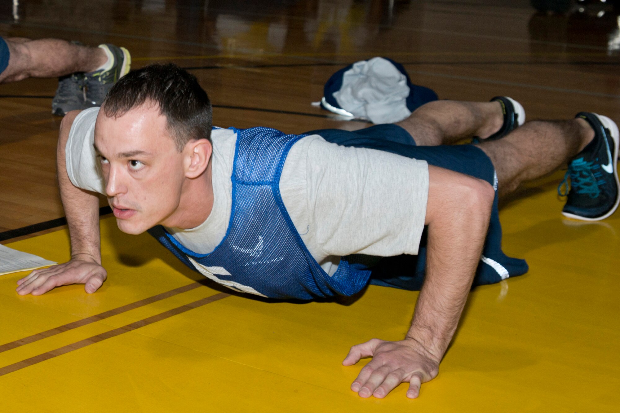 U.S. Air Force Reserve Staff Sgt. Chris Wilder, a propulsion systems journeyman assigned to the 913th Maintenance Squadron, focuses on knocking out push-ups during his physical fitness assessment test at Little Rock Air Force Base, Ark., Jan. 9, 2016. The Air Force uses and overall composite fitness score and minimum scores per component based on aerobic fitness (1.5-mile timed run), body composition (abdominal circumference measurements) and muscular fitness components (push-ups and sit-ups) to determine overall fitness. (U.S. Air Force photo by Master Sgt. Jeff Walston/Released)
