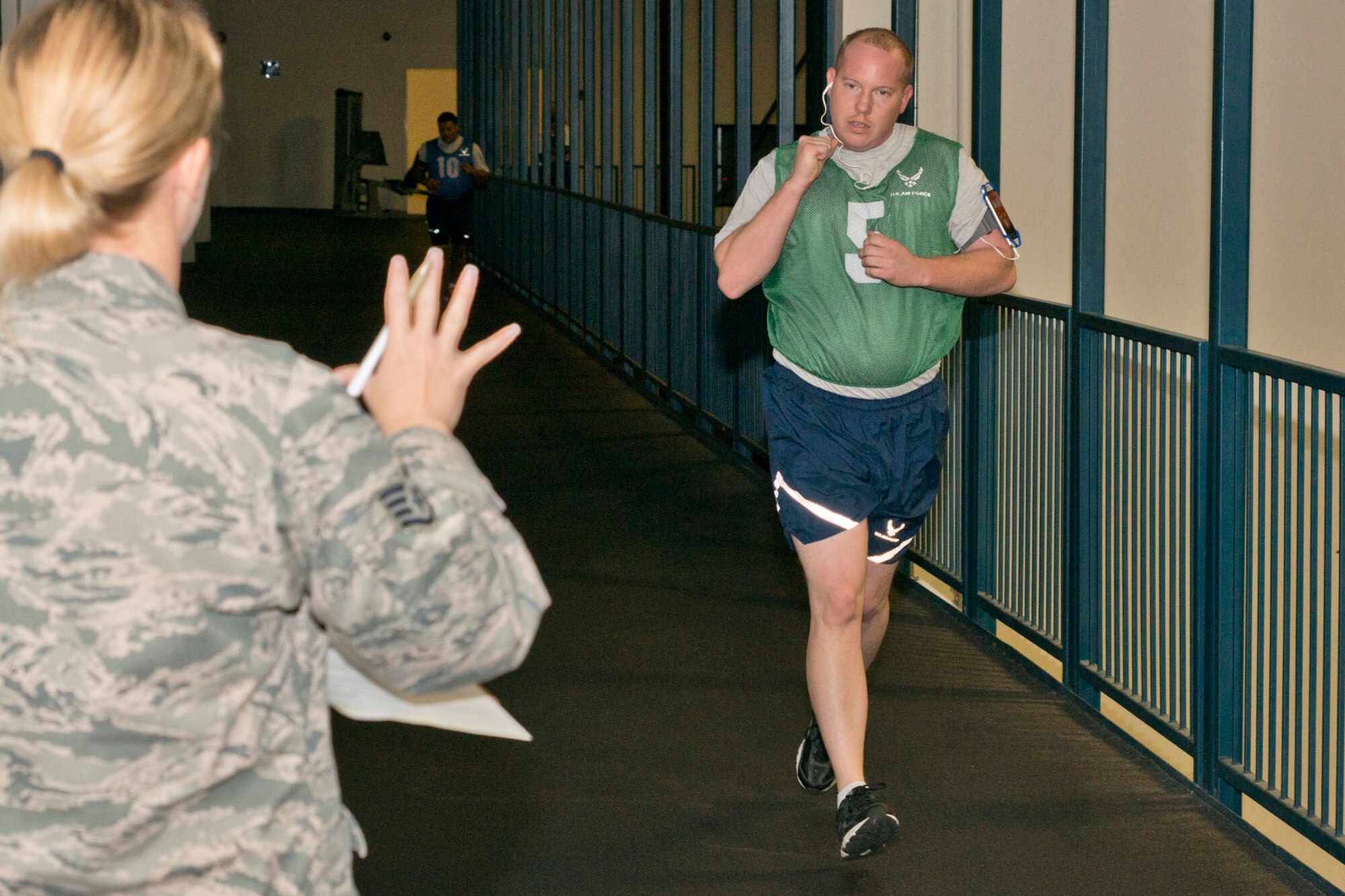 U.S. Air Force Reserve Tech. Sgt. Jason Gibson, an aerial porter assigned to the 96th Aerial Port Squadron, acknowledges five laps completed from Staff Sgt. Amber Rust, during the run portion of his physical fitness assessment test at Little Rock Air Force Base, Ark., Jan. 9, 2016. Rust, a crew chief assigned to the 913th Maintenance Squadron, volunteered as a Physical Training Leader and monitors and records scores for fellow Airmen as they completed their tests. (U.S. Air Force photo by Master Sgt. Jeff Walston/Released)