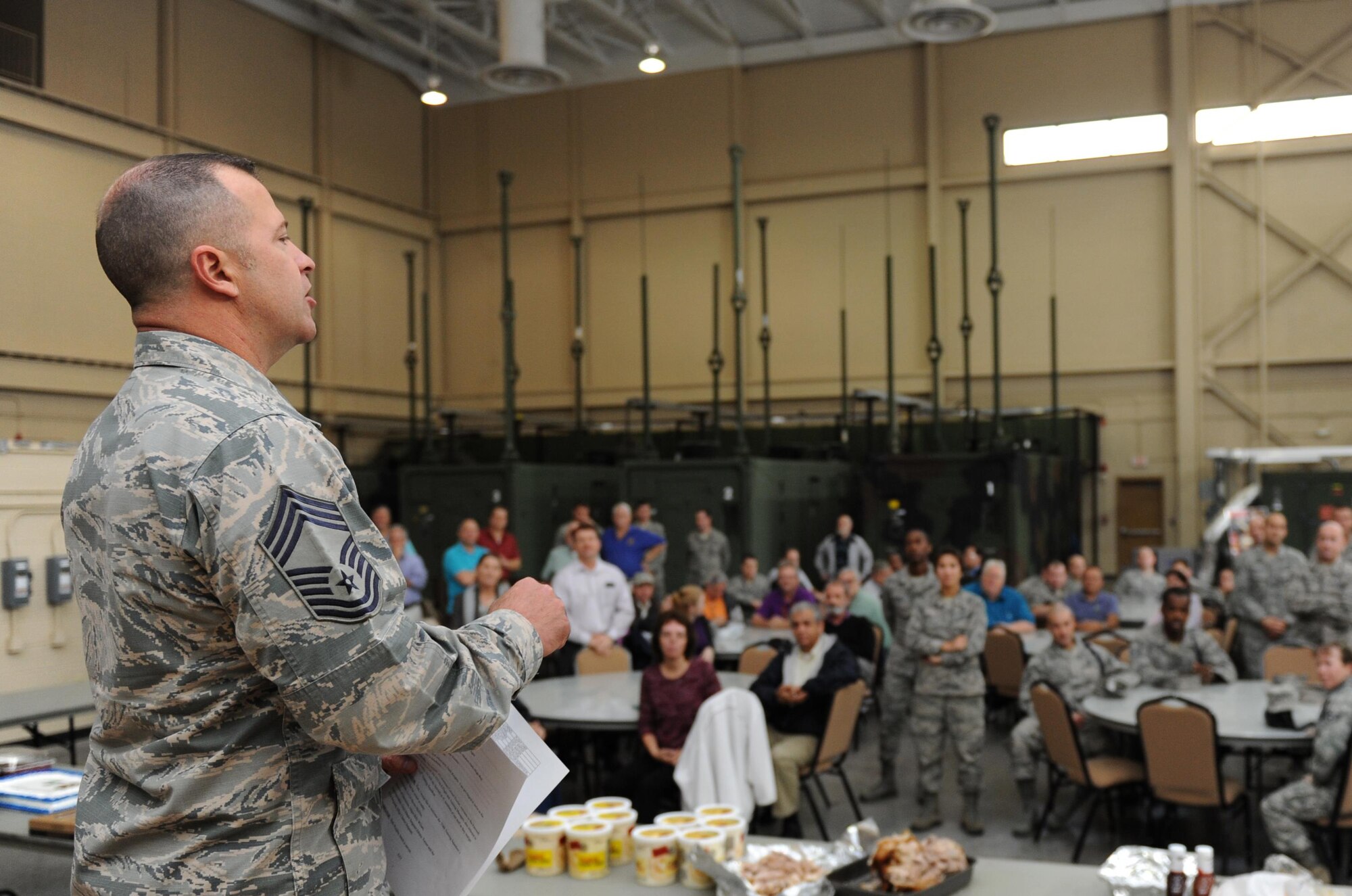 Chief Master Sgt. Derek Fromenthal, 338th Training Squadron superintendent, delivers welcoming remarks during a luncheon at Matero Hall Dec. 17, 2015, Keesler Air Force Base, Miss. Two Air Force Specialty Codes, 3D1X5 Ground Radar and 3D1X6 Airfield Systems, have been converted to 1C8X1 and 1C8X2, respectively. The 81st Training Group adjusted accordingly and realigned the 41-member flight from the 338th Training Squadron to the 334th Training Squadron effective Jan 4, 2016. The 338th TRS staff held a flight transition luncheon to thank them for their contributions and dedicated service to the unit. (U.S. Air Force photo by Kemberly Groue)