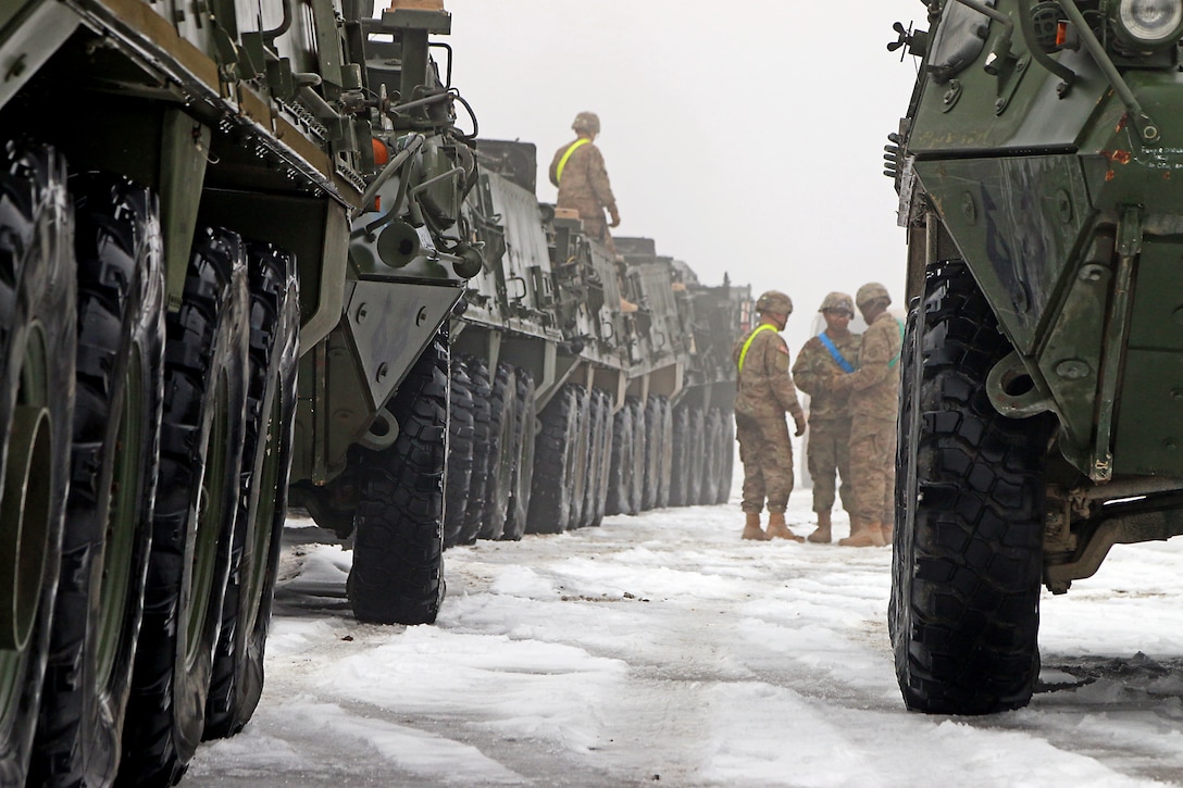 U.S. soldiers stage Stryker armored fighting vehicles before driving them from the railhead to the motor pool in Konotop, Poland, during railhead operations, Jan. 11, 2016. U.S. Army photo by Sgt. Paige Behringer