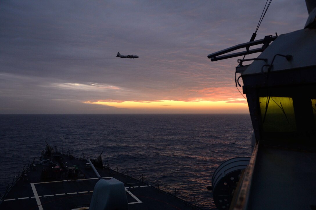 A U.S. Navy P-3C Orion aircraft flies over USS Ross in the Mediterranean Sea, Jan. 10, 2016. U.S. Navy photo by Petty Officer 2nd Class Justin Stumberg