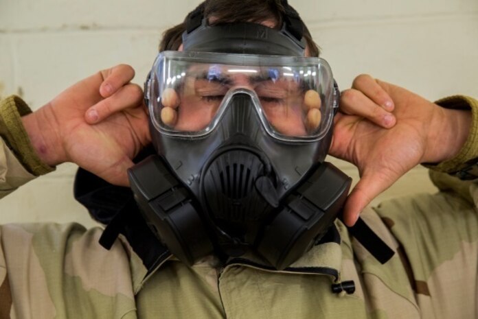 A Marine with 2nd Marine Logistics Group breaks the seal on his mask after entering the gas chamber at Camp Lejeune, N.C., Jan. 8. Marines, while exposed to chlorobenzylidene malononitrile, or CS gas, must conduct a series of exercises before breaking the seal on their mask followed by properly don and clearing it. The chamber is a routine exercise to ensure the durability of each Marine's gear while exposed to chlorobenzylidene malononitrile, or CS gas, which is a bi-annual qualification requirement for Marines. (U.S. Marine Corps photo by Lance Cpl. Preston McDonald/Released)