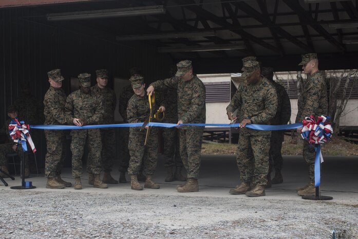 Brig. Gen. Charles Chiarotti, commanding general for 2nd Marine Logistics Group, and one of the 8th Engineers Support Battalion Marines that helped renovate the unit’s new Corporals Course, cuts the ceremonial ribbon to open the facility at Camp Lejeune, N.C., Jan. 6, 2016. This renovated facility is now open to train the Marines and sailors of 2nd MLG. (U.S. Marine Corps photo by Cpl. Fatmeh Saad/Released )