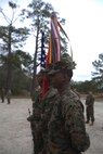 The color guard prepares to present the colors to begin the ribbon cutting ceremony to unveil 2d Marine Logistics Groups new traning facility for corporals course at Camp Lejeune, N.C., Jan. 6, 2016. Marines from various MLG units gathered to witness the reveal of the renvated space. (U.S. Marine Corps photo by Lance Cpl. Miranda Faughn/released)