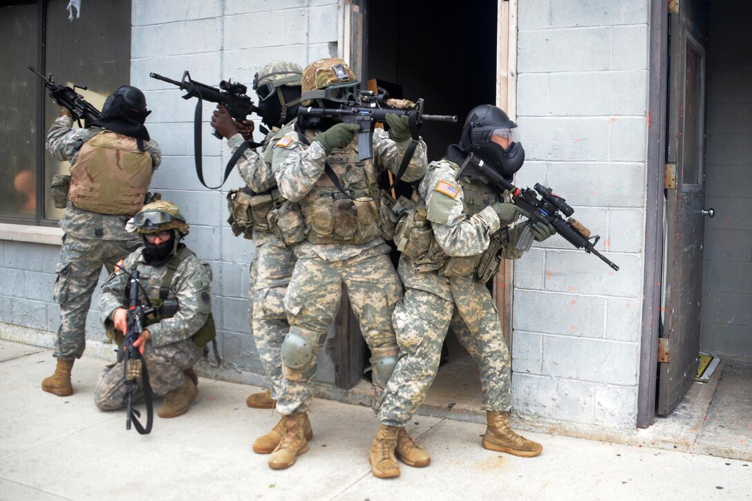 New York Army National Guardsmen maneuver along a building during tactical training at the New York Police Department training facility and range at Rodman’s Neck, New York, Jan. 9, 2016. New York Army National Guard photo