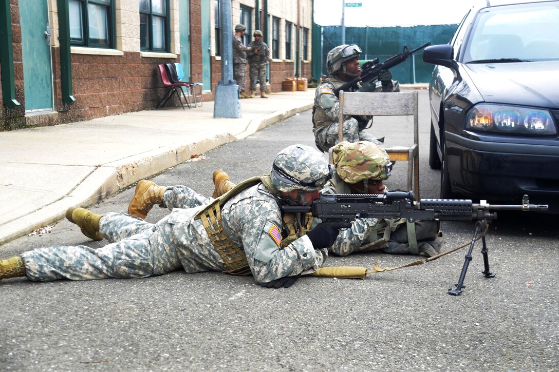New York Army National Guardsmen provide security for other soldiers maneuvering outside a building during tactical training at the New York Police Department training facility and range at Rodman’s Neck, New York, Jan. 9, 2016. New York Army National Guard photo