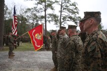 U.S. Navy Capt. Bill Muhm, 2nd Marine Logistics Group chaplain, salutes as the colors are presented before the new 2nd MLG Corporals Course building during a ribbon cutting ceremony at Camp Lejeune, N.C., Jan. 6, 2016. Officers and enlisted Marines from various MLG units gathered to unveil the new training center, which is now open for use. (U.S. Marine Corps photo by Lance Cpl. Miranda Faughn/Released)