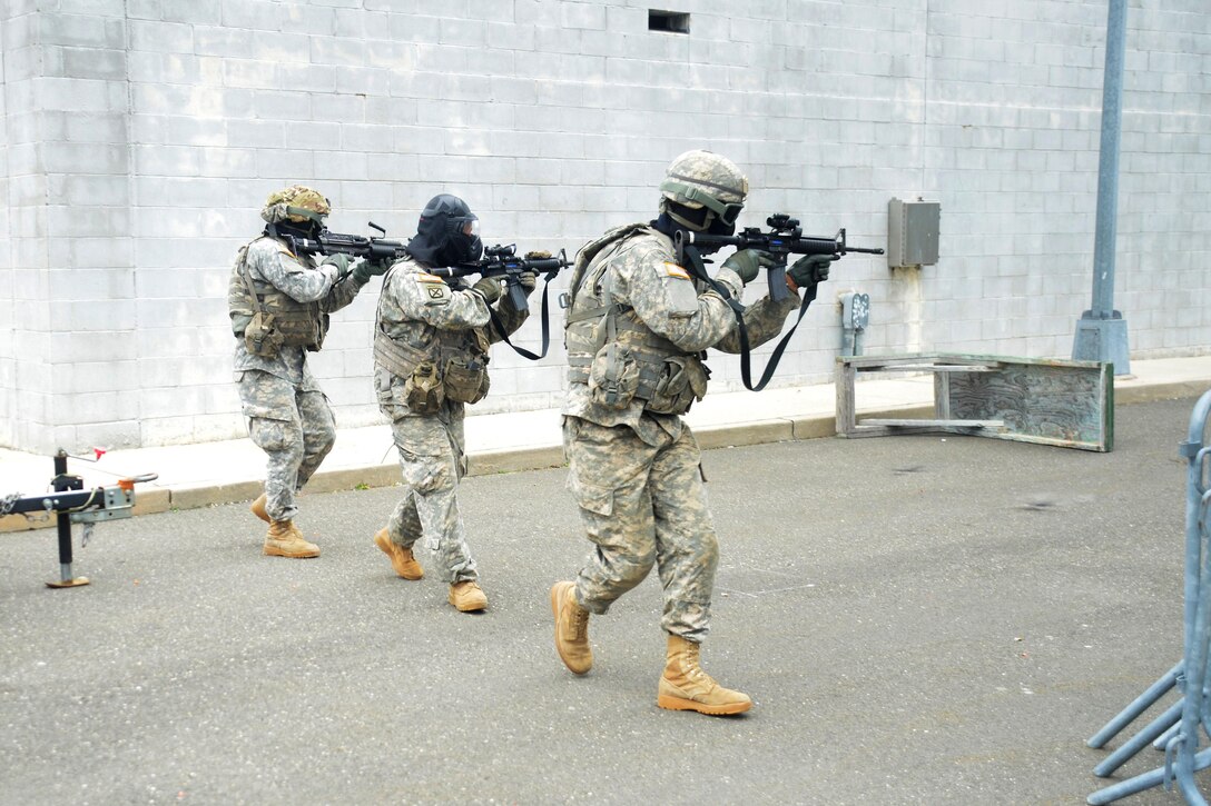 New York Army National Guardsmen advance to their next objective during tactical training at the New York Police Department training facility and range at Rodman’s Neck, New York, Jan. 9, 2016. New York Army National Guard photo
