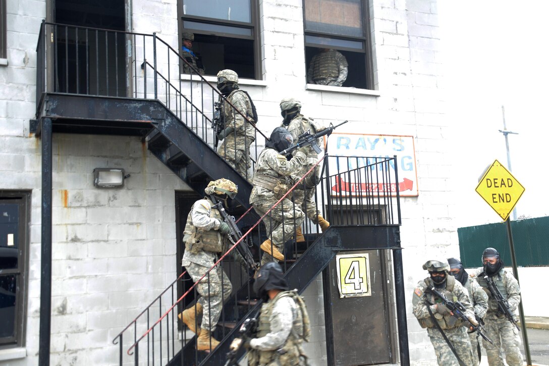 New York Army National Guardsmen advance up a staircase to search a building during tactical training at the New York Police Department training facility and range at Rodman’s Neck, New York, Jan. 9, 2016. New York Army National Guard photo