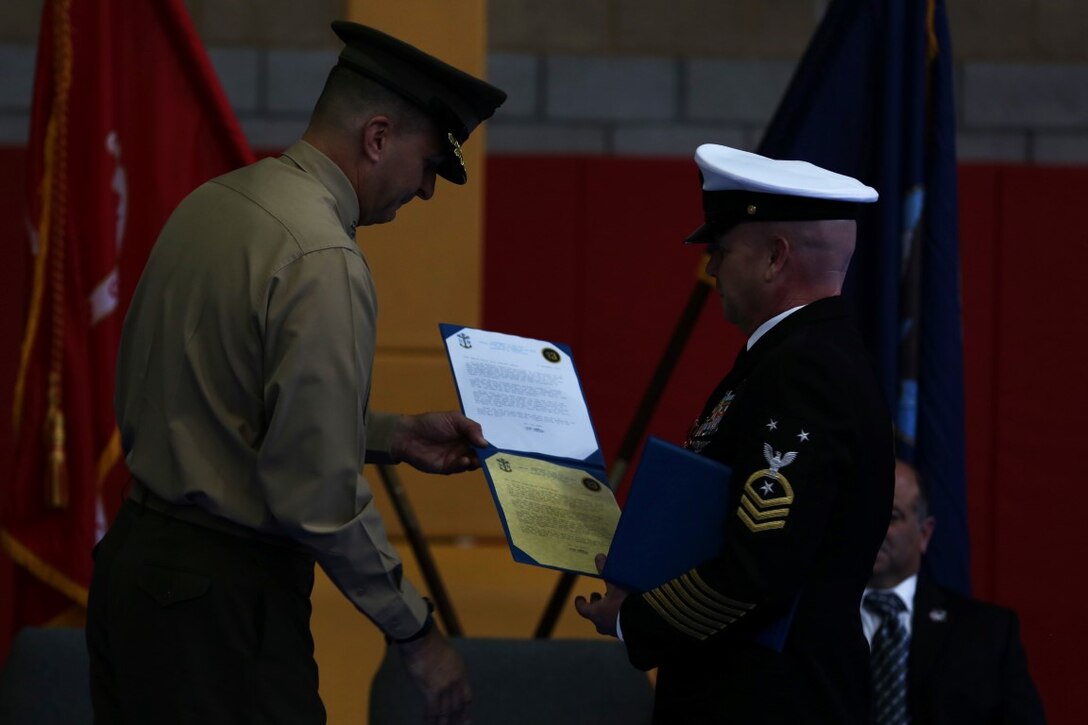 Master Chief Petty Officer Robert Lemons (right), the command master chief with of the 1st Marine Division, receives his retirement certificates from Maj. Gen. Daniel O’Donohue (left), commanding general of the 1st Mar. Div., during Lemons’ retirement ceremony aboard Marine Corps Base Camp Pendleton, Calif., Jan. 8, 2016. Lemons enlisted in the U.S. Navy in 1986 and served a majority of his time in the service as a corpsman.
