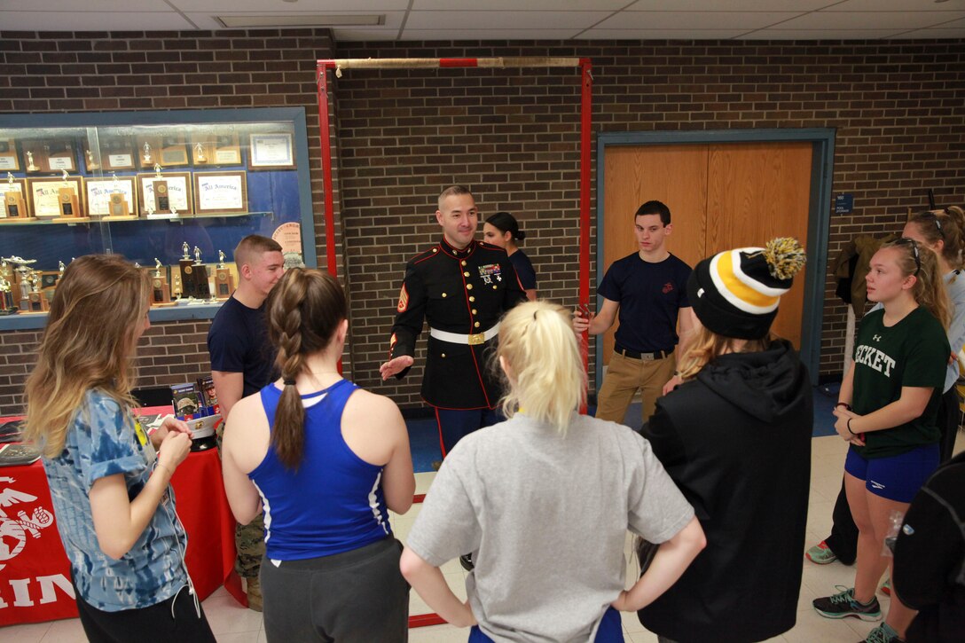 Staff Sgt. Jason Caldwell, a recruiter with Recruiting Station Springfield, speaks to students about the intangible benefits of the Marine Corps during a track meet at Staples High School in Westport, Conn., Jan. 9, 2016. During the track meet Sports Illustrated and the Marine Corps recognized Hanna DeBalsi as the December athlete of the month. 