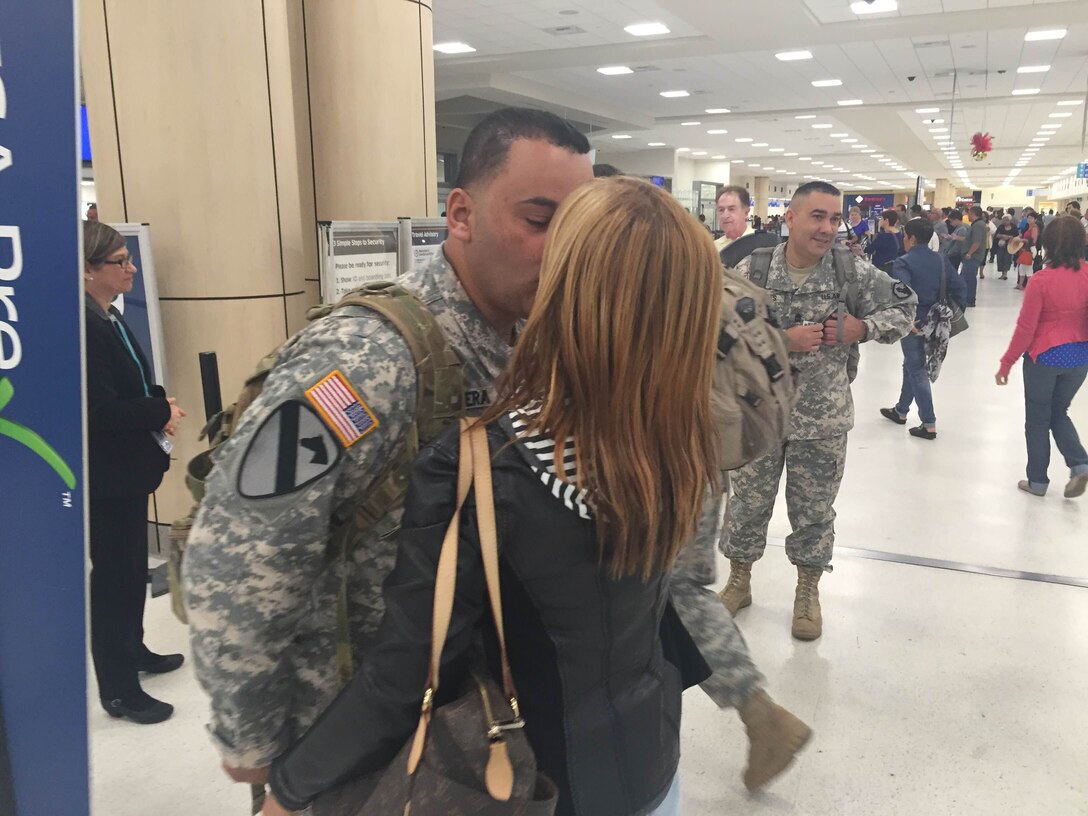 Lt. Col. Carlos Rivera says good-bye to his wife before heading to mobilization training in Texas on January 5, 2016. 