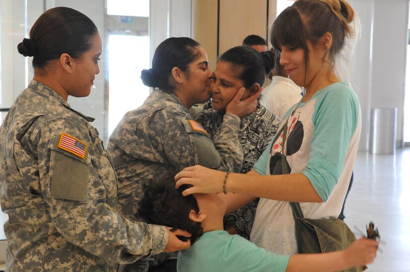 Soldiers say good-bye to their family members before heading off to their mobilization training site in Texas on January 12, 2016.