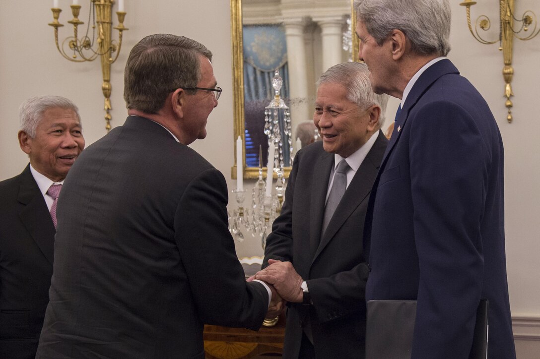 Defense Secretary Ash Carter, left center, shakes hands with Philippine Foreign Secretary Albert del Rosario as Secretary of State John Kerry, right, and Philippine Defense Secretary Voltaire Gazmin stand by before a meeting at the State Department in Washington, D.C., Jan. 12, 2016. The leaders met to discuss matters of mutual importance. DoD photo by Air Force Senior Master Sgt. Adrian Cadiz