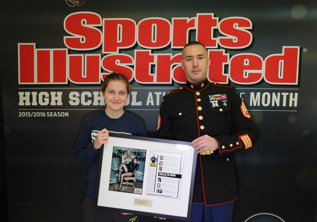 Hannah DeBalsi, Athlete of the Month from Staples High School, is presented with a plaque by Staff Sergeant Jason Caldwell on behalf of the U.S. Marine Corps and Sports Illustrated,  Jan. 9, 2016 at Staples High School, Westport, Conn. DeBalsi received the award for excellence in cross-country, her desire to give back to her community and her superior performance in her academics. 
