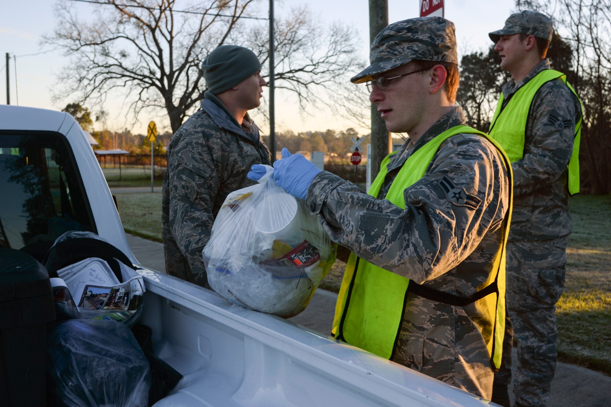 U.S. Air Force Airman 1st Class Jordon Rogers, 23d Operations Support Squadron air traffic control apprentice, places a garbage bag in a collection truck, Jan. 12, 2016, at Moody Air Force Base, Ga. During the patrol, a vehicle made rounds collecting full bags of trash from volunteers. (U.S. Air Force photo by Airman 1st Class Janiqua P. Robinson/Released)
