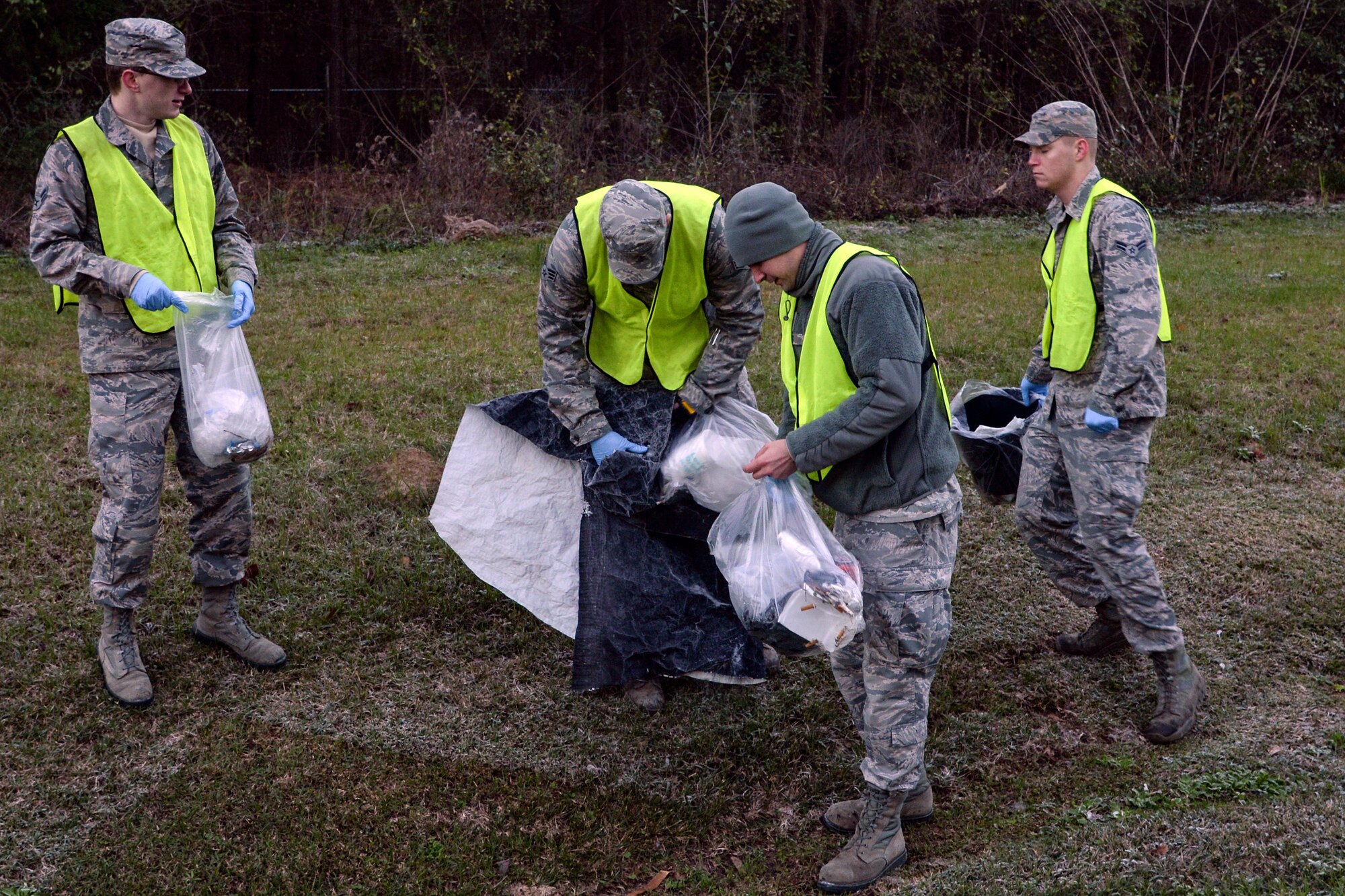 U.S. Air Force Airmen from the 23d Fighter Group gather and consolidate litter during a Pride Patrol clean-up, Jan. 12, 2016, at Moody Air Force Base, Ga. Airmen wore reflective vests during the Pride Patrol as a safety precaution so people driving on the highway would easily see them. (U.S. Air Force photo by Airman 1st Class Janiqua P. Robinson/Released)