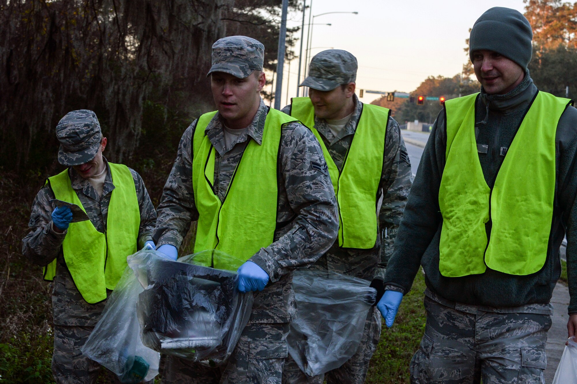 U.S. Air Force Airmen from the 23d Fighter Group collect roadside debris during a Pride Patrol clean-up, Jan. 12, 2016, at Moody Air Force Base, Ga. Airmen braved cold weather to help clean up along the base border during one of the first Pride Patrols of the new year. (U.S. Air Force photo by Airman 1st Class Janiqua P. Robinson/Released)