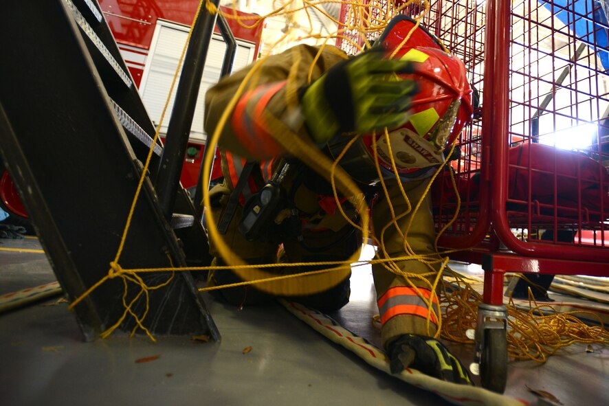 U.S. Air Force Staff Sgt. Christopher Crusius, 20th Civil Engineer Squadron fire and emergency services firefighter, attempts to de-tangle himself from hanging ropes during a confidence course at Shaw Air Force Base, S.C., Jan. 11, 2016. While blindfolded, Crusius had to feel his way along a narrow path laid out for him by a fire hose. (U.S. Air Force photo by Airman 1st Class Kelsey Tucker)