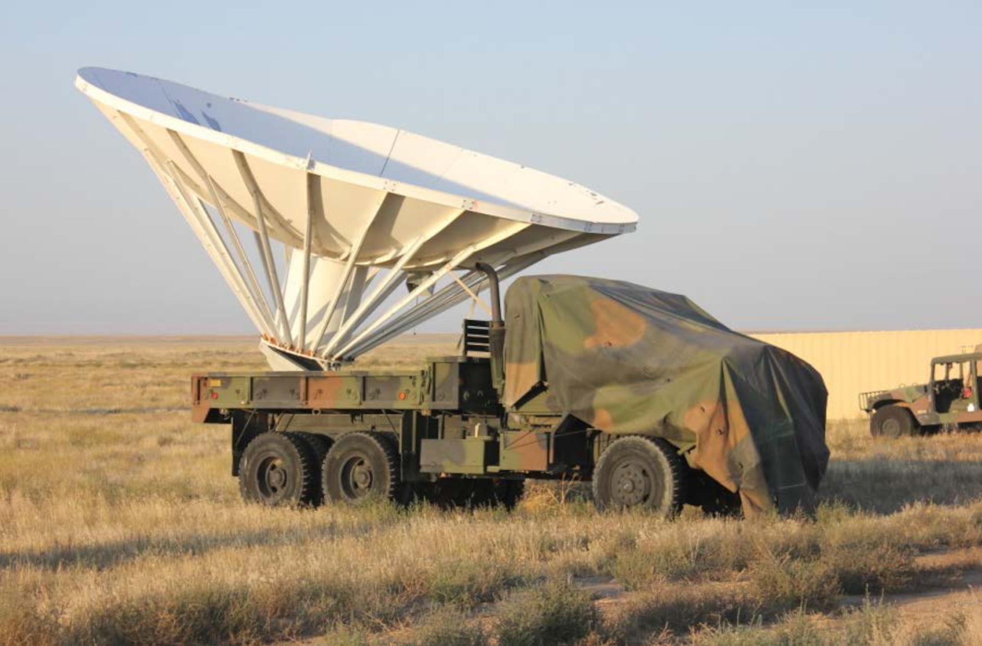 A five-ton vehicle carrying a 30-foot radar dish stands ready at Saylor Creek Range Complex, Idaho. Contract range personnel modified the vehicle to create a target capable of being relocated for different mission needs. (Courtesy photo)