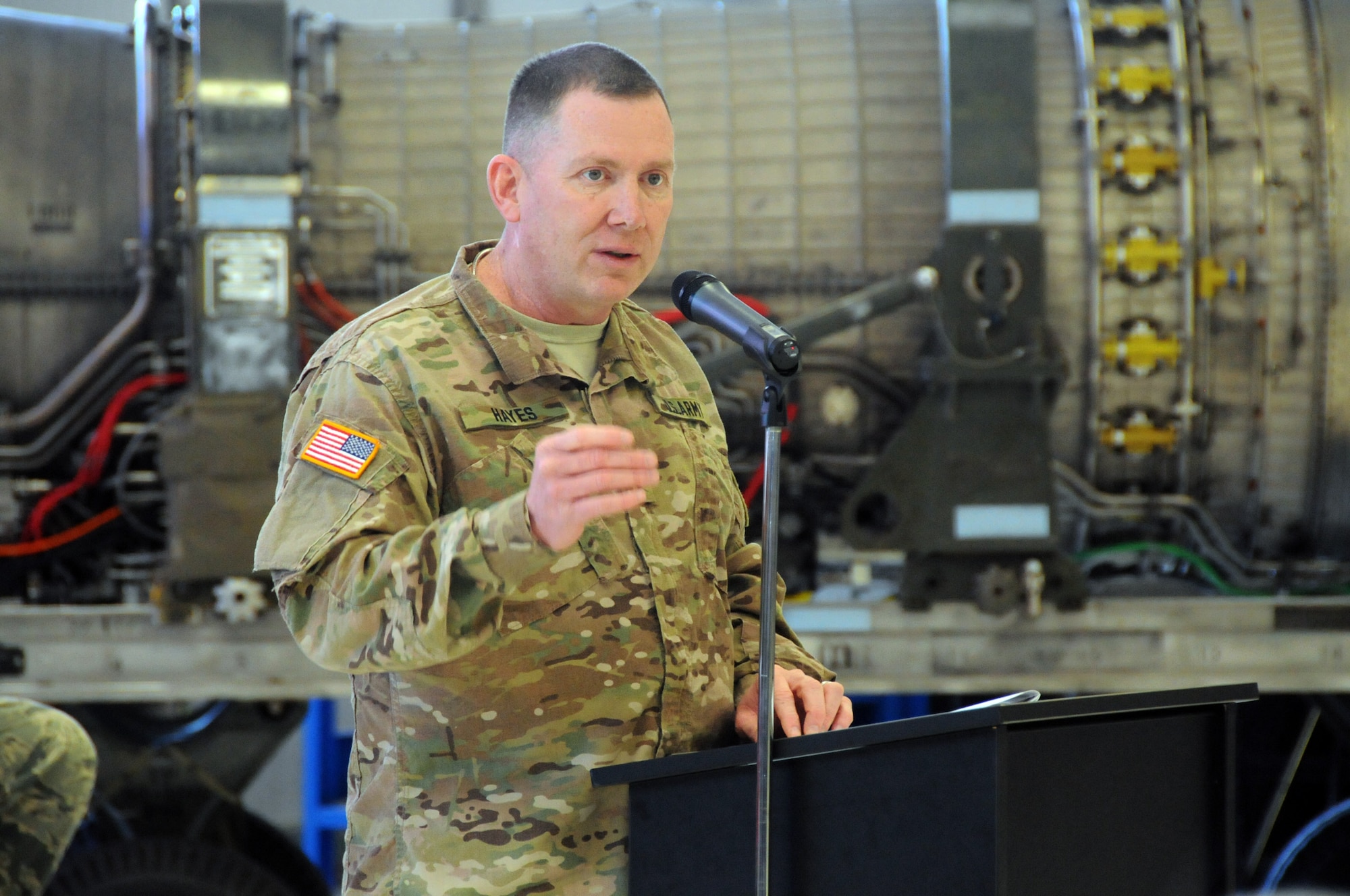 The Adjutant General of Illinois, Maj. Gen. Richard J. Hayes, Jr., addresses the members of the 183rd Air Operations Group during an activation ceremony Jan. 10, 2016 in Springfield, Illinois. The Illinois Air National Guard unit is responsible for command and control missions in combat theaters around the world.  Hayes stands in front of an F16 engine.  The unit also repairs F16 engines and recently began testing A10 engines.  (U.S.  Air National Guard photo by Master Sgt. Shaun Kerr/Released)