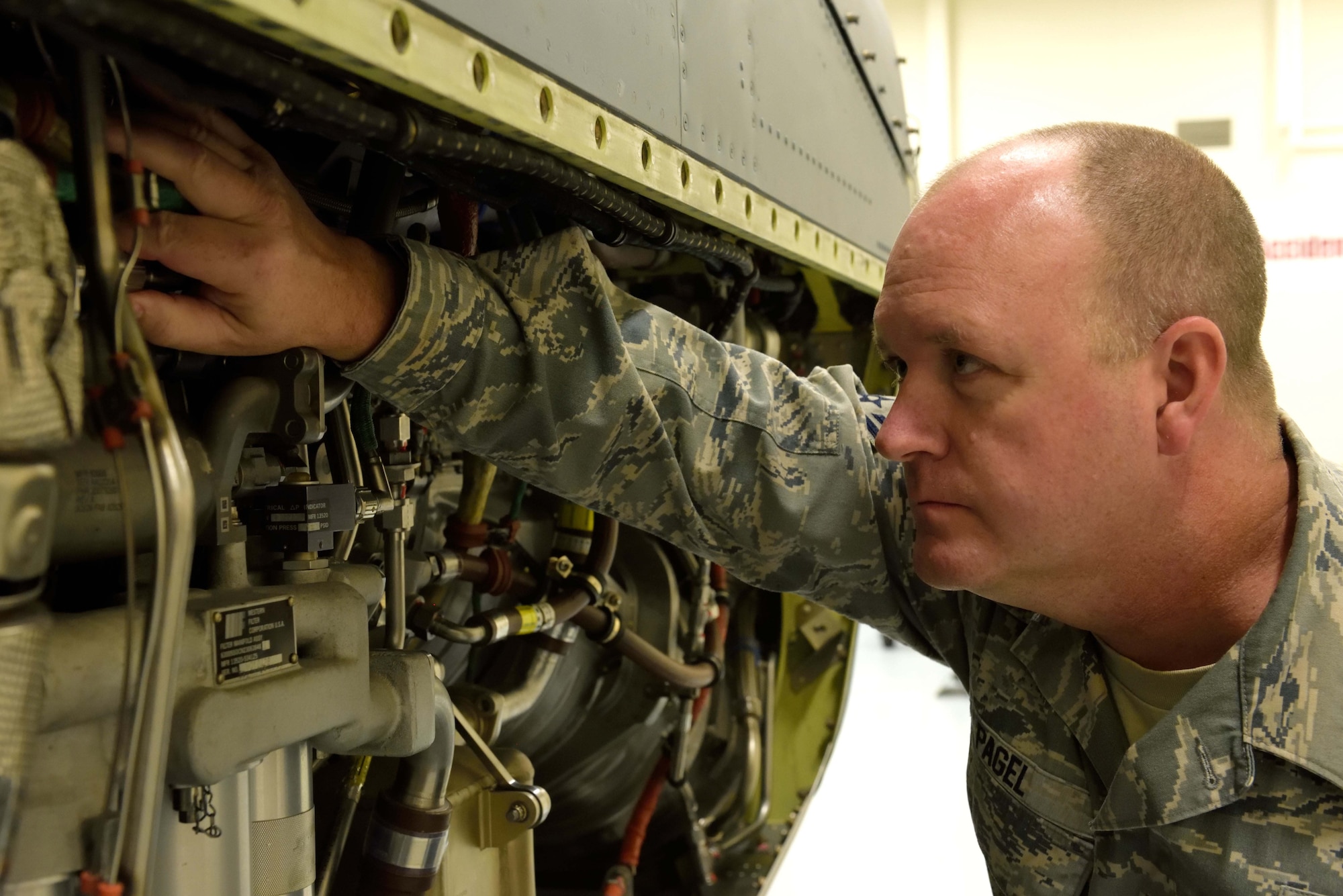 Staff Sgt. Timothy Pagel, 403rd Maintenance Squadron aerospace propulsion technician, inspects an engine removed from a C-130J in the Roberts Consolidated Aircraft Maintenance Facility at Keesler Air Force Base, Mississippi, Jan. 10, 2016. Pagel was one of several 403rd Wing members who served in the military during Operations Desert Shield and Desert Storm 25 years ago. (U.S. Air Force photo/Tec. Sgt. Ryan Labadens)