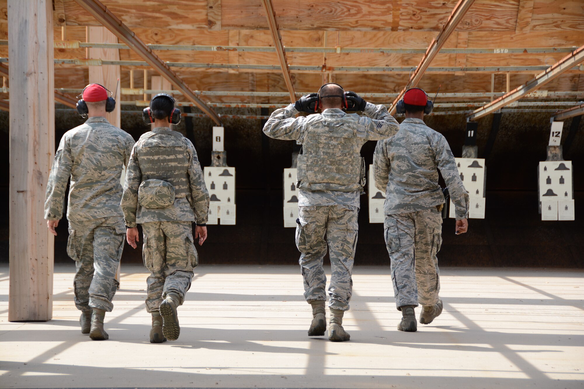 Four Combat Arms Training and Maintenance instructors from the 507th Security Forces Squadron walk out to check targets at the firing range after Airmen fire their M-4 carbines during weapons qualification Oct. 3, 2015, at Tinker Air Force Base, Okla. Reservists interested in joining the Security Forces career field are eligible to receive an enlistment bonus of up to $20,000 for committing to a six-year enlistment, and prior-service Airmen interested in retraining into the field are eligible for a bonus of up to $15,000. (U.S. Air Force photo by Tech. Sgt. Lauren Gleason)
