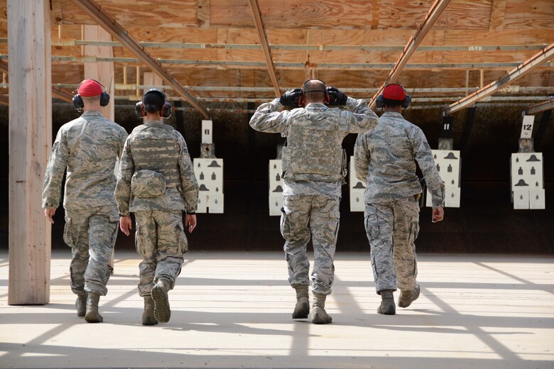 Four Combat Arms Training and Maintenance instructors from the 507th Security Forces Squadron walk out to check targets at the firing range after Airmen fire their M-4 carbines during weapons qualification Oct. 3, 2015, at Tinker Air Force Base, Okla. Reservists interested in joining the Security Forces career field are eligible to receive an enlistment bonus of up to $20,000 for committing to a six-year enlistment, and prior-service Airmen interested in retraining into the field are eligible for a bonus of up to $15,000. (U.S. Air Force photo by Tech. Sgt. Lauren Gleason)
