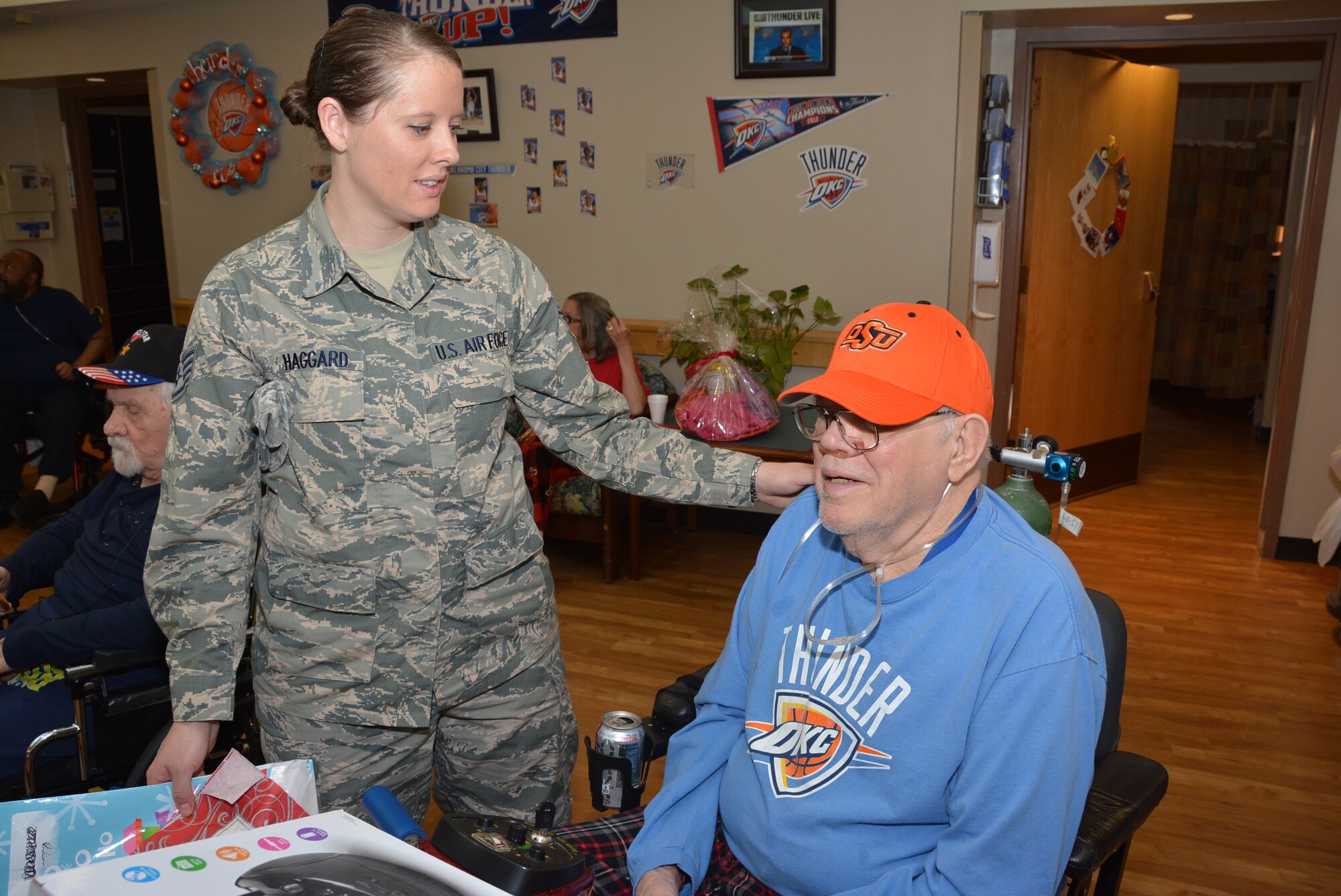 Staff Sgt. Sarah Haggard of the 507th Air Refueling Wing, Tinker Air Force Base, Okla., talks with Veteran Richard Guthrie, Dec. 22, 2015, at the Norman Veterans Center in Norman, Okla. Guthrie served more than 20 years in the Air Force, and in addition to multiple deployments, he logged more than 22,000 flight hours flying over Vietnam, Korea and Libya. (U.S. Air Force photo/Maj. Jon Quinlan)