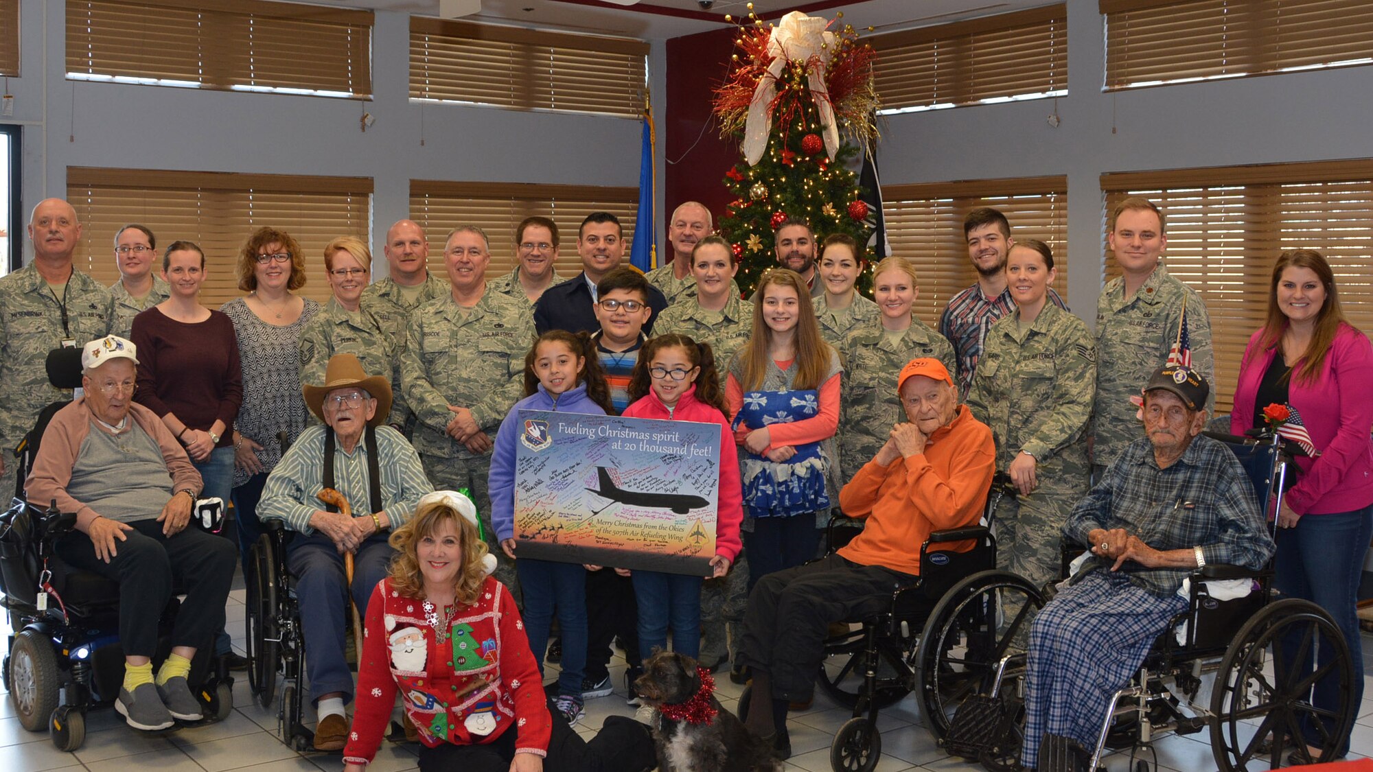 Twenty-five Reservists, family members and civilians from the 507th Air Refueling Wing, Tinker Air Force Base, Okla., pose for a group photo with Veterans at the Angel Tree party Dec 22, 2015, at the Norman Veterans Center in Norman, Okla. Twenty Veterans had their wish lists filled by members of the 507th ARW. In addition to filling wish lists, members of the 507th ARW, the 1st Aviation Standards Flight and the 513th Air Control Group also contributed nearly $700 in donations to the Veteran’s Benefit Fund, which is used to pay for costs associated with field trips and other recreational activities. Courtesy photo/Kelly Davis 