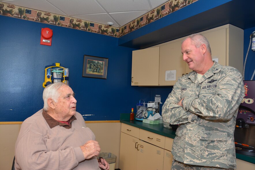 Billy Malone, a U.S. Navy Veteran, discusses his role in the Navy with Col. Brian S. Davis, commander of the 507th Air Refueling Wing, Tinker Air Force Base, Okla., Dec. 22, 2015, at the Norman Veterans Center in Norman, Okla.  Malone and his seven brothers all served in the U.S. military. (U.S. Air Force photo/Maj. Jon Quinlan)