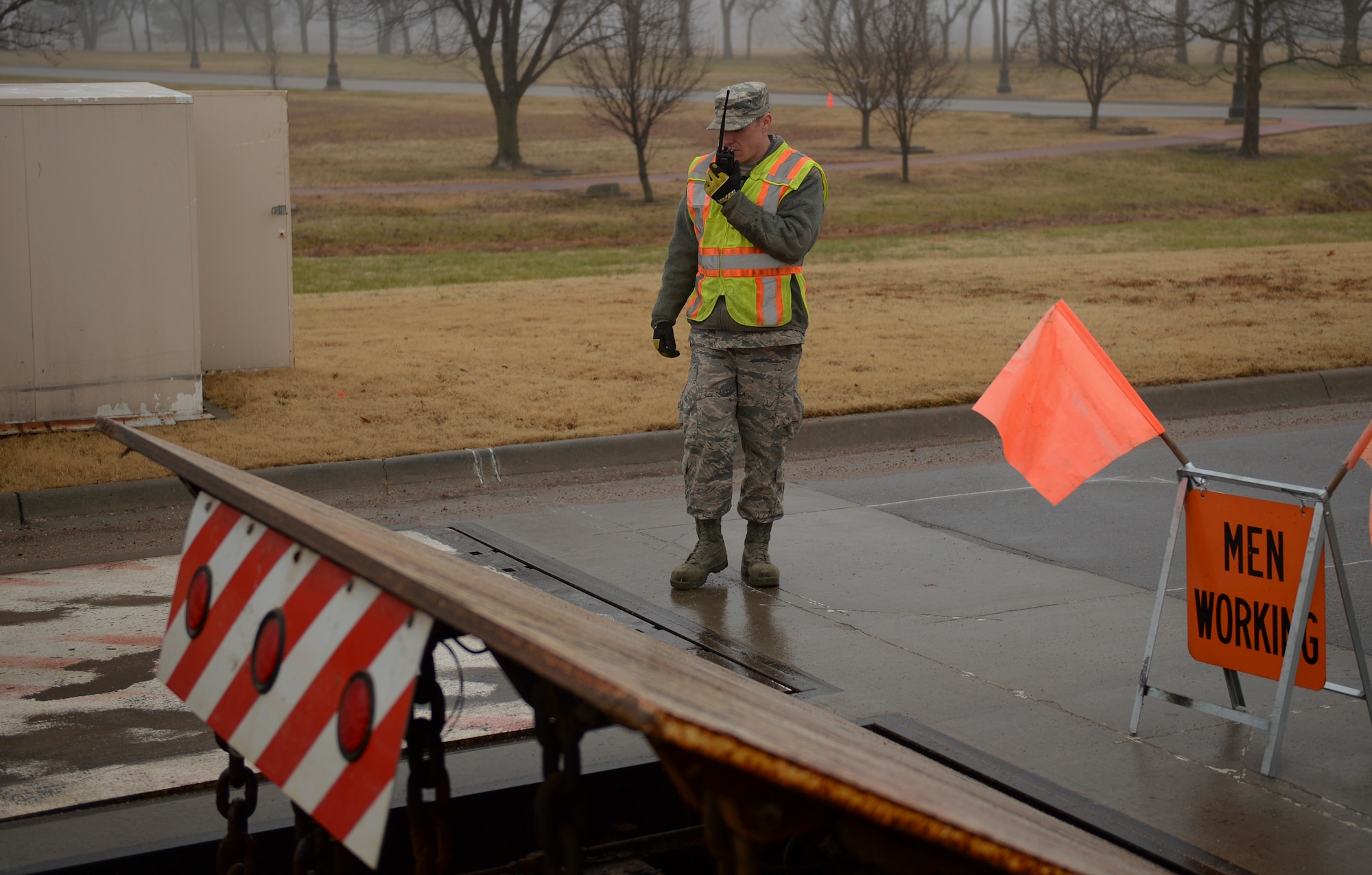 Senior Airman Ethan Gruntorad, 22nd Civil Engineer Squadron electrical power production journeyman, speaks with another 22nd CES Airmen in the security forces guard shack, Jan. 7, 2016, at McConnell Air Force Base, Kan. The Airmen communicate with each other in order to test and troubleshoot road barriers at the entrance and exit of the base. (U.S. Air Force photo/Senior Airman Colby L. Hardin)