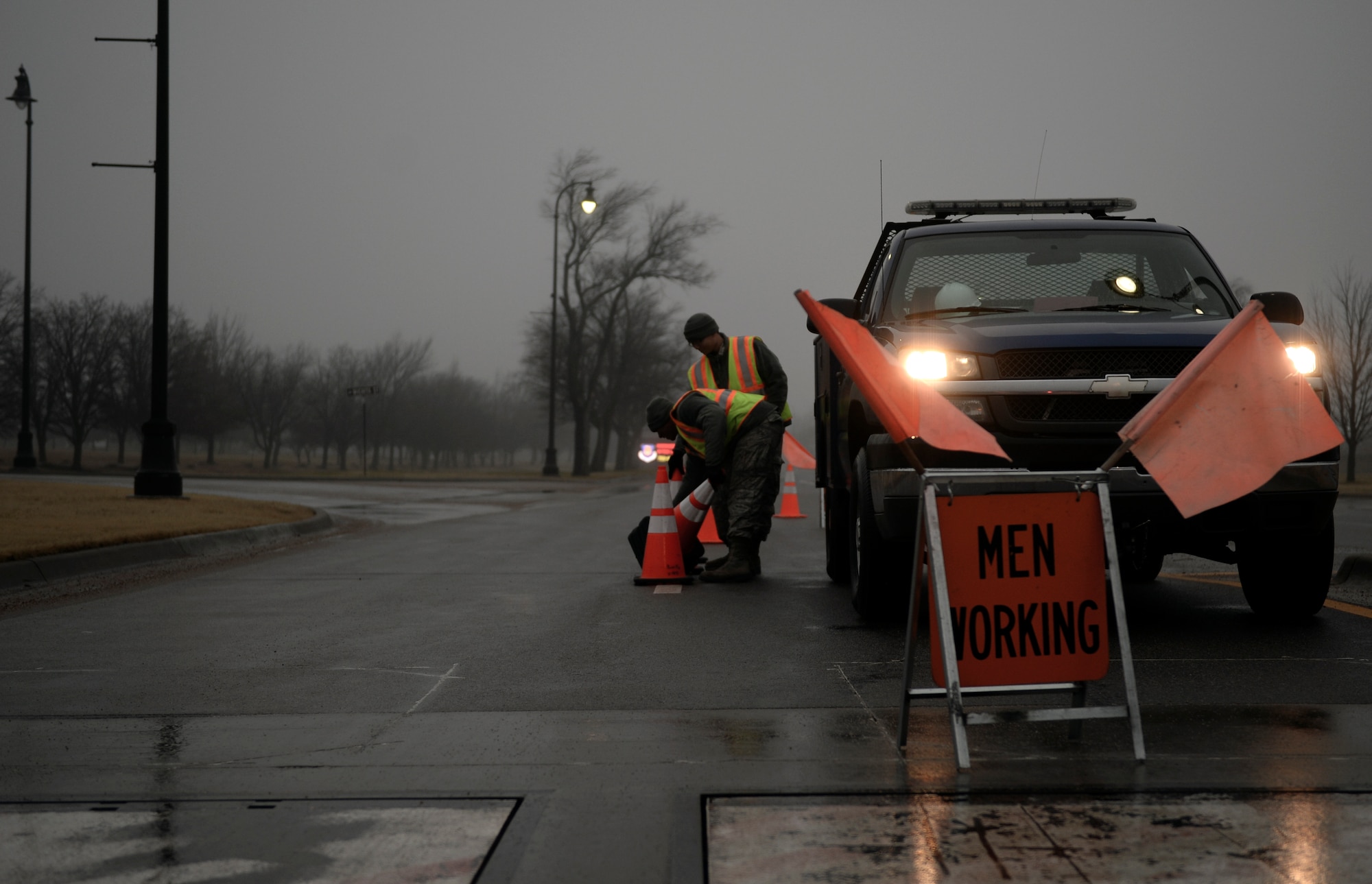 Members of the 22nd Civil Engineer Squadron electrical power production shop, set cones on the street, Jan. 7, 2016, at McConnell Air Force Base, Kan. The 22nd CES perform routine barrier checks to help ensure the safety of Team McConnell.  (U.S. Air Force photo/Senior Airman Colby L. Hardin)