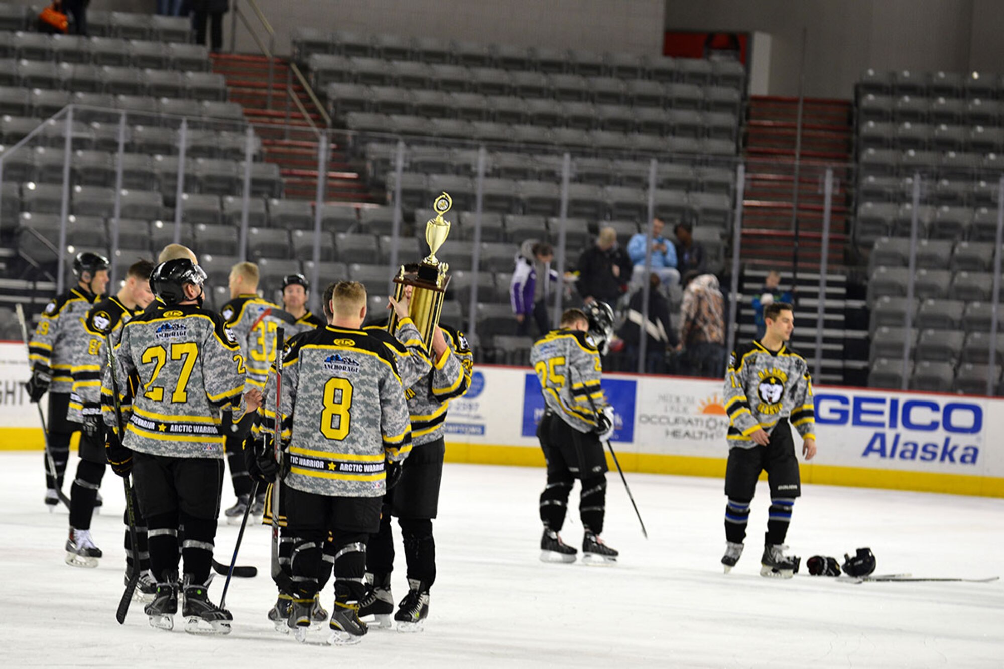 The Joint Base Elmendorf-Richardson, Alaska U.S. Army hockey team celebrates with their newly awarded trophy at the Sullivan Arena Jan. 9 after winning JBER's Air Force vs. Army hockey match. The Army came back from a 4-1 point deficit to win the game in a shoot-out and a final score of 7-6. (Air Force photo by Airman 1st Class Kyle Johnson/Released)