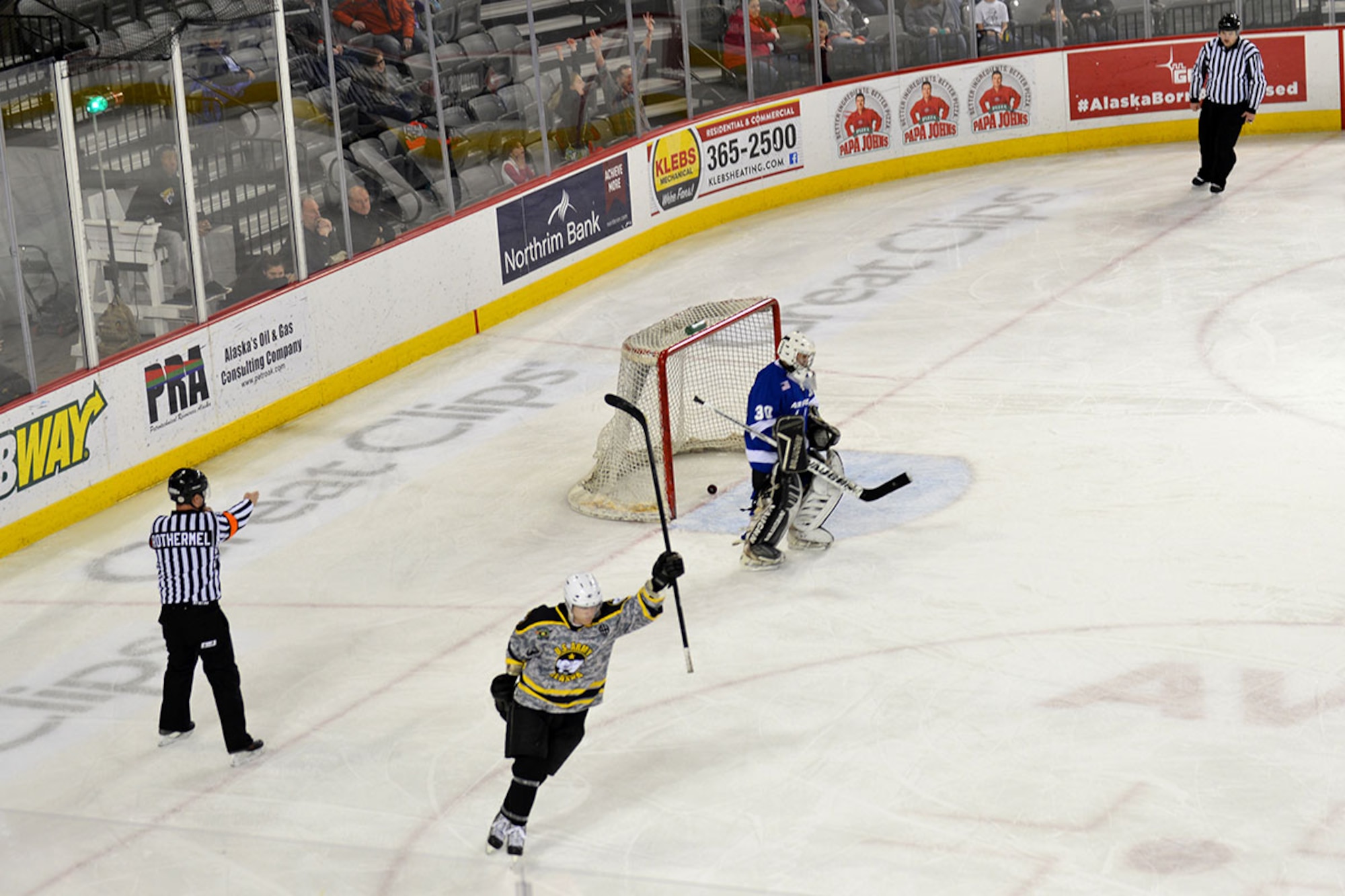 A Joint Base Elmendorf-Richardson Army hockey player scores the winning goal against the Air Force team at the Sullivan Arena, Jan 9. The Army came back from a 4-1 point deficit to win the game in a shoot-out and a final score of 7-6. (Air Force photo by Airman 1st Class Kyle Johnson/Released)