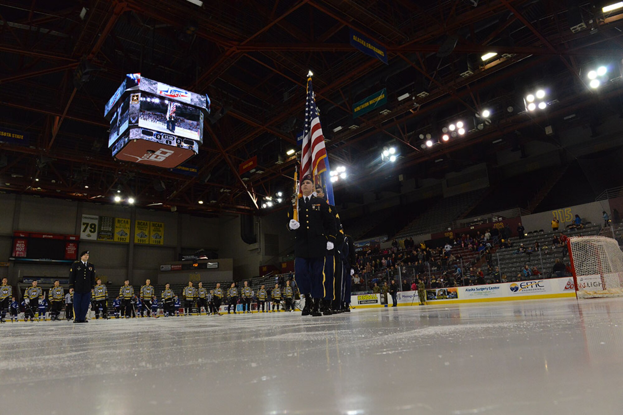 Members of the U.S. Air Force and Army honor guard leave the ice after U.S. and Canadian national anthems just before the Air Force vs. Army Hockey game at the Sullivan Arena Jan 9. The Army came back from a 4-1 point deficit to win the game in a shoot-out with a final score of 7-6. (Air Force photo by Airman 1st Class Kyle Johnson/Released)