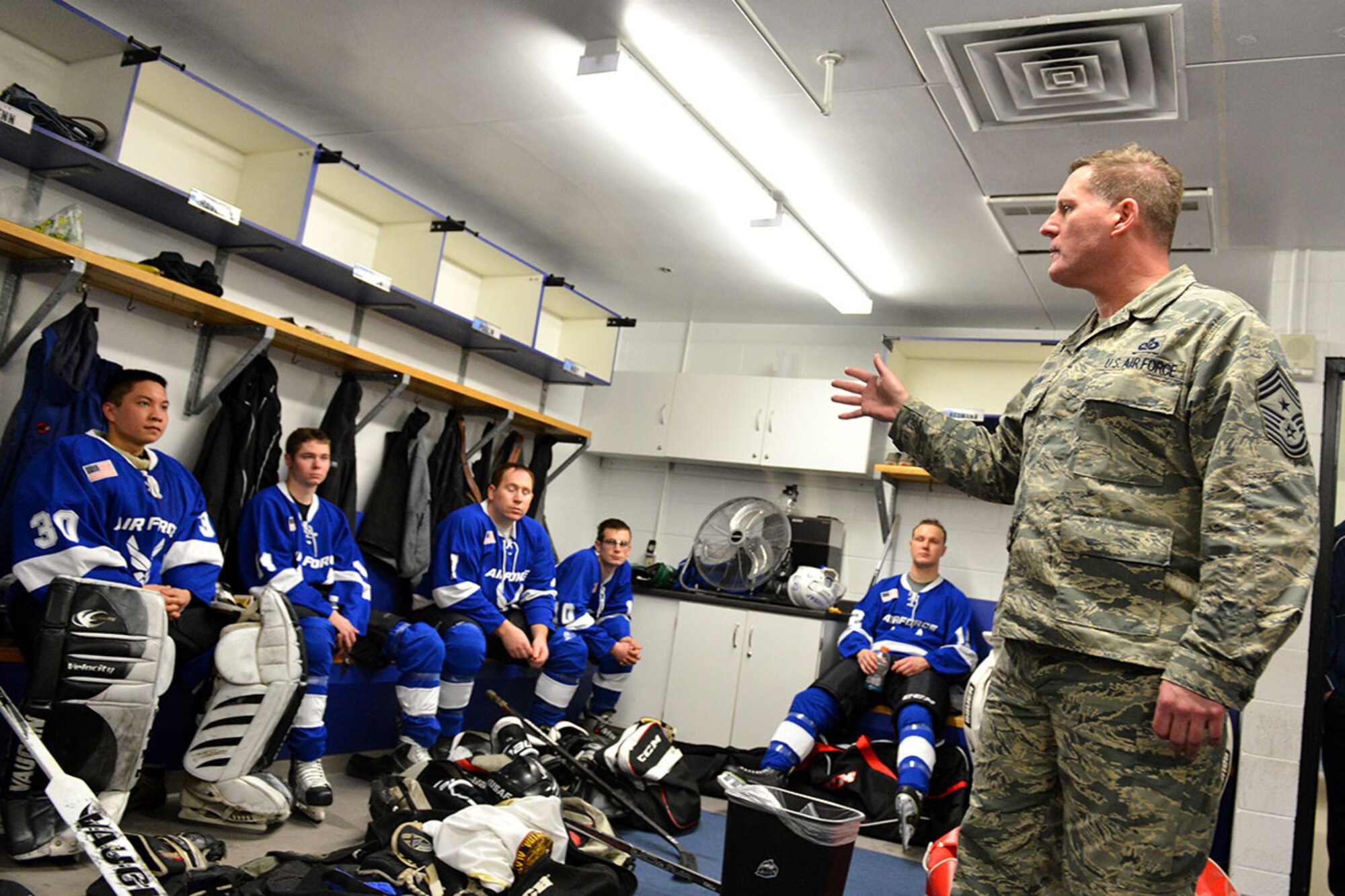The coach for Joint Base Elmendorf-Richardson's Air Force hockey team, 176th Air National Guard Command Chief Master Sgt. Steven Calvin, gives his players one last pep talk at the Sullivan Arena locker rooms as they move into the second half of the JBER Air Force vs. Army hockey match Jan 9. The Army came back from a 4-1 point deficit to win the game in a shoot-out and a final score of 7-6. (Air Force photo by Airman 1st Class Kyle Johnson/Released)