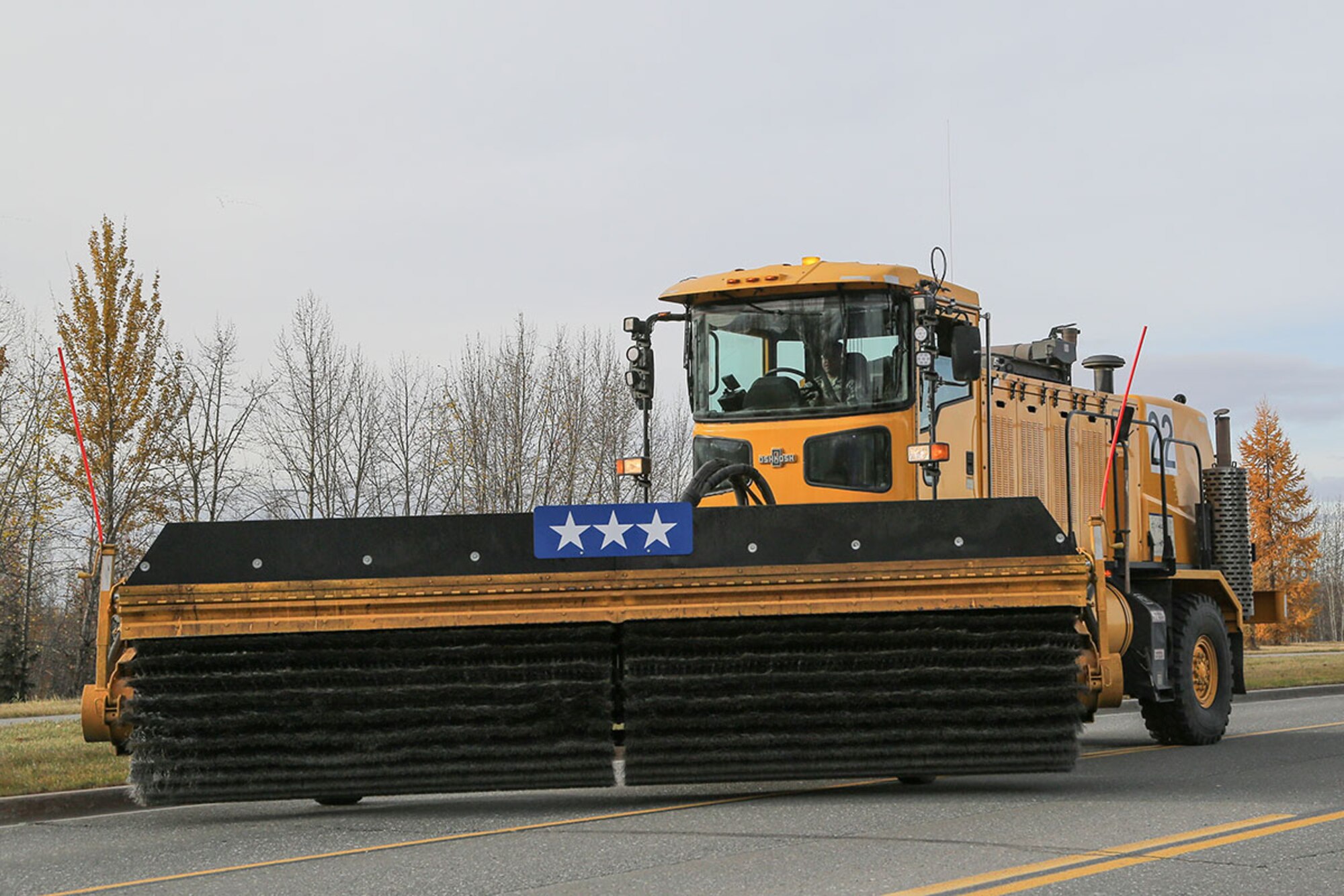 A member of the 773d Civil Engineering Squadron operates snow removal equipment during the annual Snow & Ice Parade on Joint Base Elmendorf-Richardson, Alaska, Oct. 9, 2015. The 773d CES snow barn is in charge of clearing the airfield and the base streets during inclement weather. (U.S. Air Force photo by Alejandro Pena)