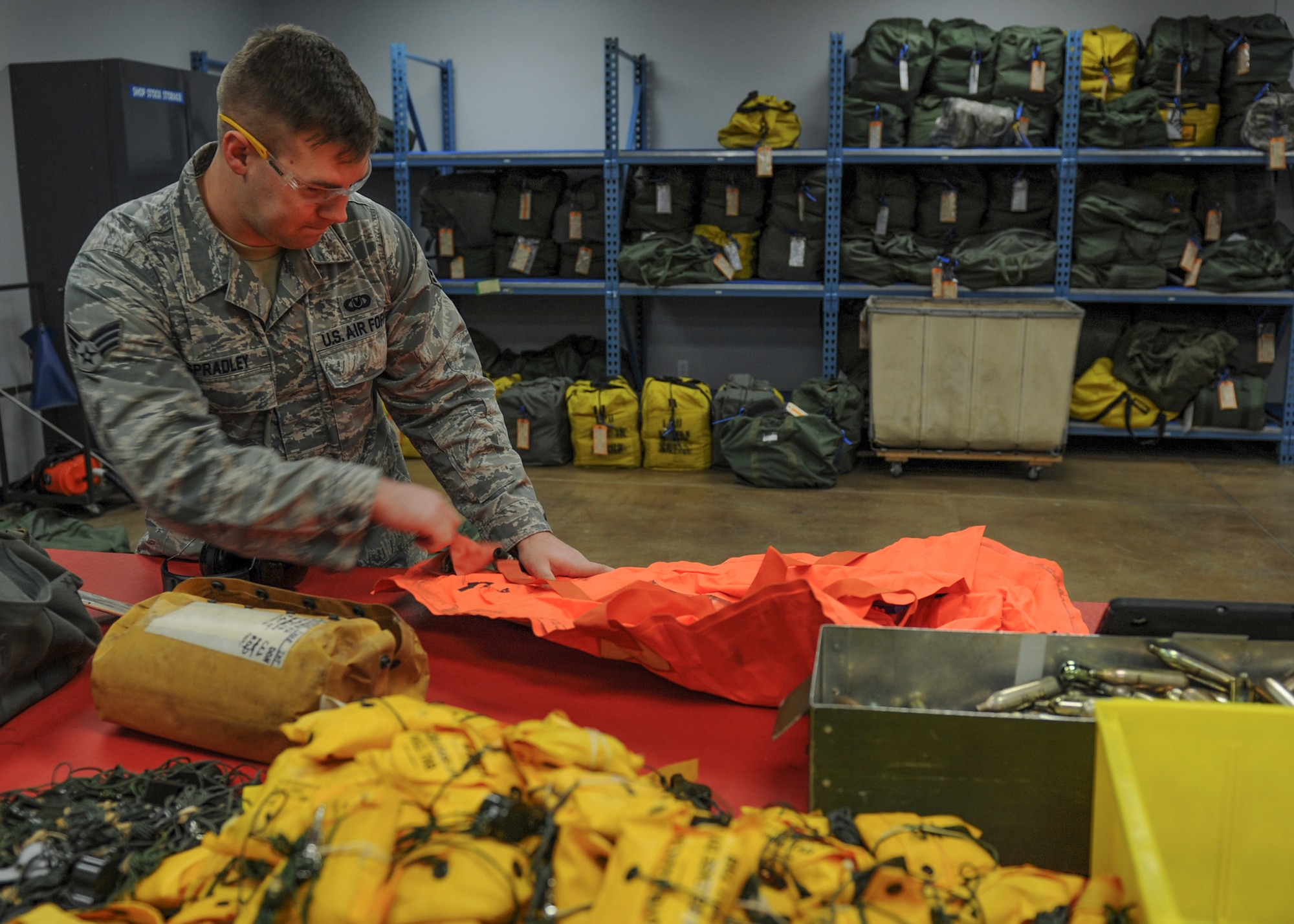 U.S. Air Force Senior Airman Niall Spradley, 19th Operations Support Squadron aircrew flight equipment journeyman, inflates an infant cot life preserver to detect any potential leaks Jan. 11, 2016, at Little Rock Air Force Base, Ark. The aircrew flight equipment team prepares C-130 Airmen for a diverse set of missions with a variety of equipment. (U.S. Air Force photo/Senior Airman Harry Brexel)