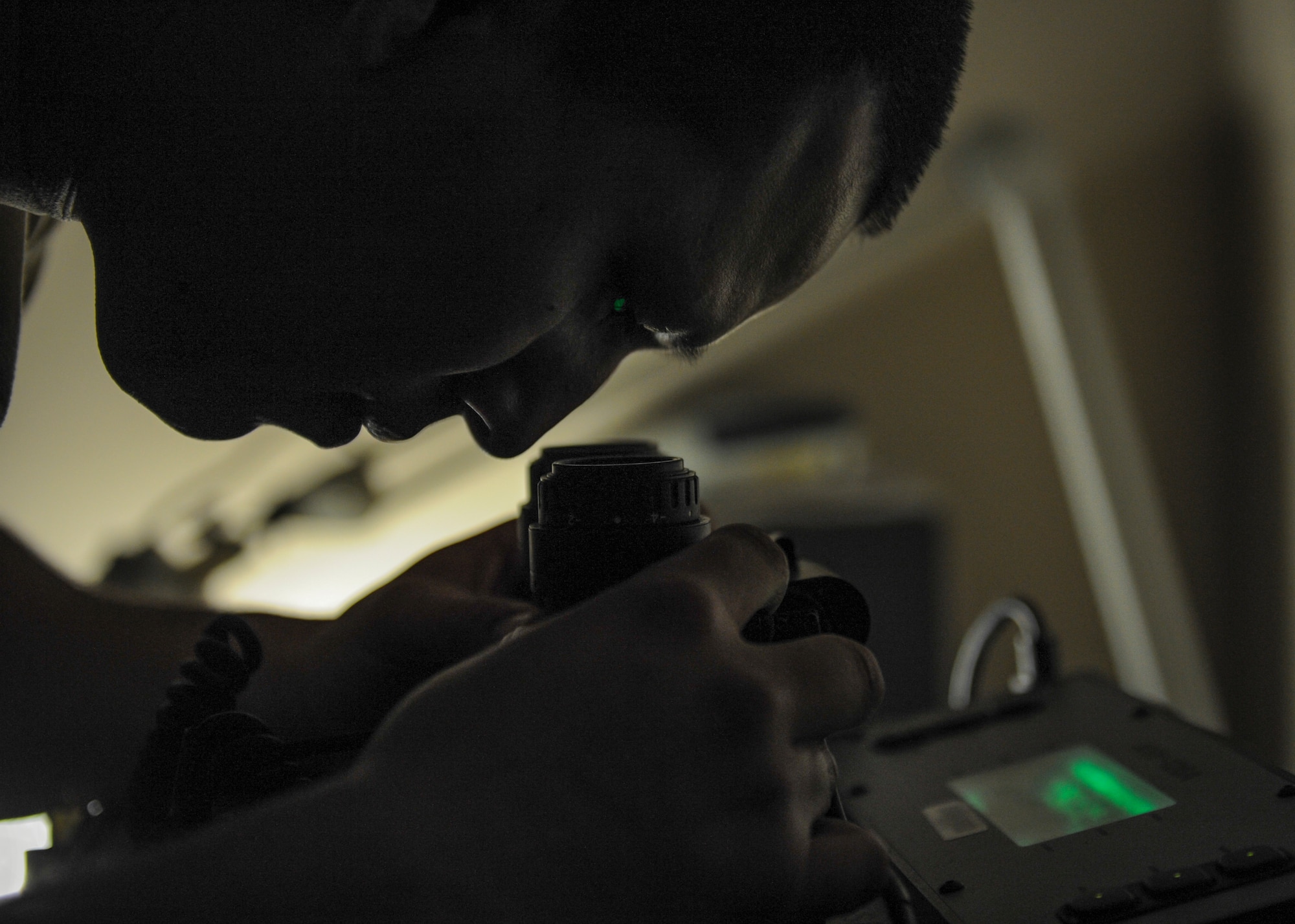 U.S. Air Force Senior Airman Sergio Bravo, 19th Operations Support Squadron aircrew flight equipment journeyman, looks for any spots or defects on a pair of night vision goggles Jan. 11, 2016, at Little Rock Air Force Base, Ark. NVGs are routinely used by C-130 pilots and loadmasters during night operations.   (U.S. Air Force photo/Senior Airman Harry Brexel)