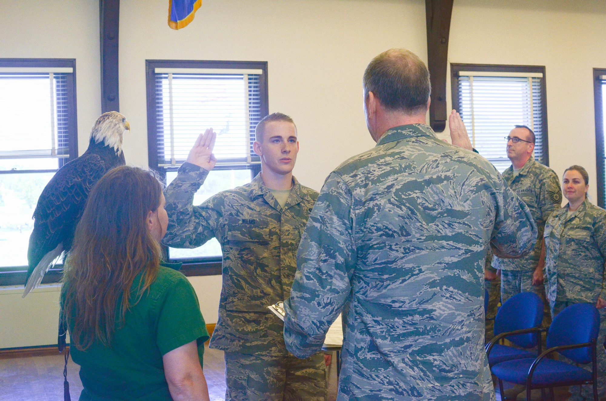 During the Jefferson Barracks Family Picnic, Staff Sgt. Zane Wilms re-enlisted as a knowledge operations manager with 157th Air Operations Group commander, Col. Richard Chapman on September 13, 2015. Liberty, a bald eagle from the World Bird Sanctuary stood watch during the ceremony. (U.S. Air National Guard photo by Staff Sgt. Brittany Cannon)