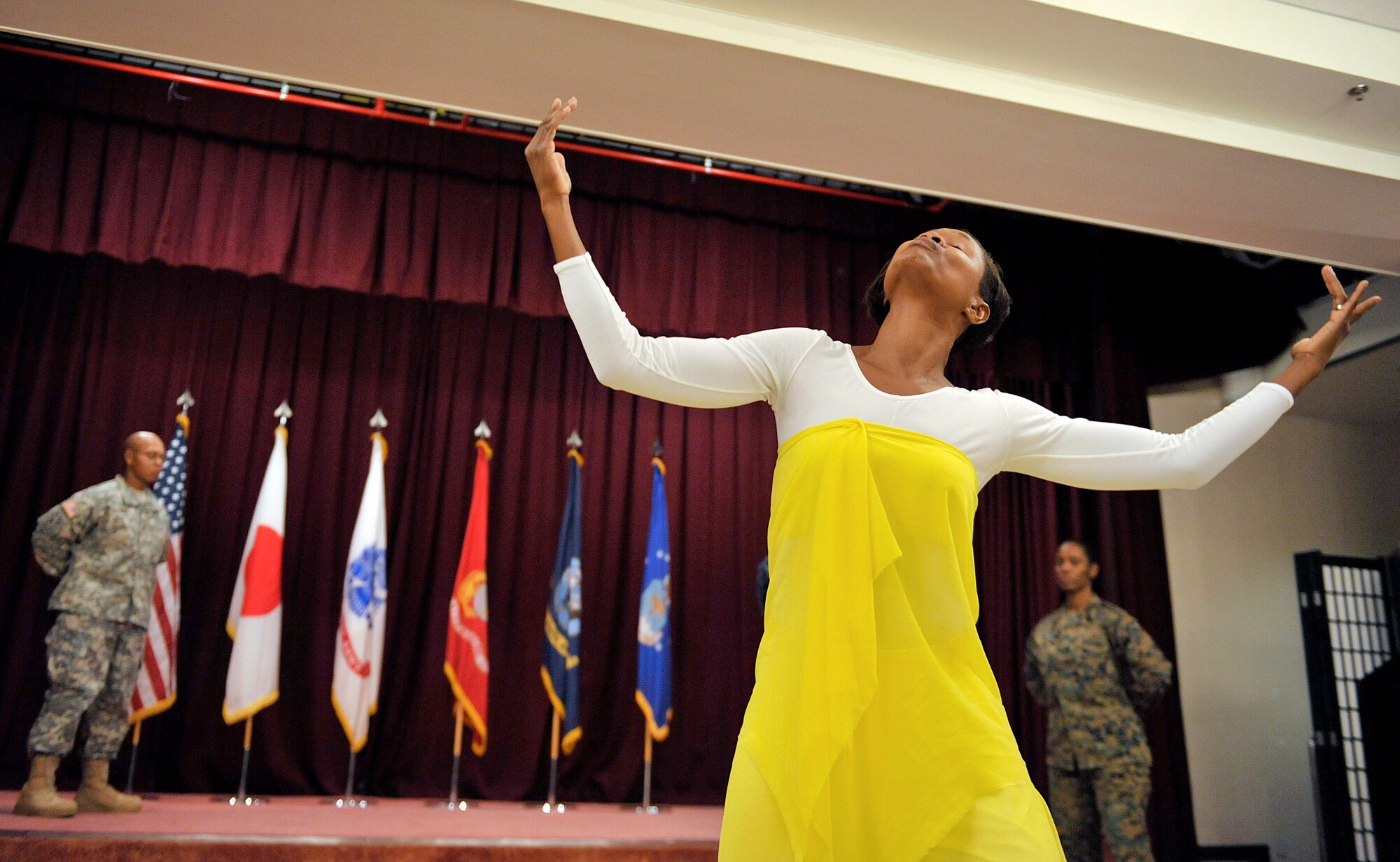 Ms. Trancye Foster, wife of Senior Master Sgt. Cedric Foster, 18th Force Support Squadron career assistance advisor, performs a praise dance during the annual Dr. Martin Luther King Jr. Day memorial luncheon at the Kadena Officers' Club, Jan. 12, 2016, at Kadena Air Base, Japan. Each year on the third Monday of January, schools, federal offices, post offices and banks across America close as we celebrate the life of Dr. Martin Luther King Jr. (U.S. Air Force photo by Naoto Anazawa)