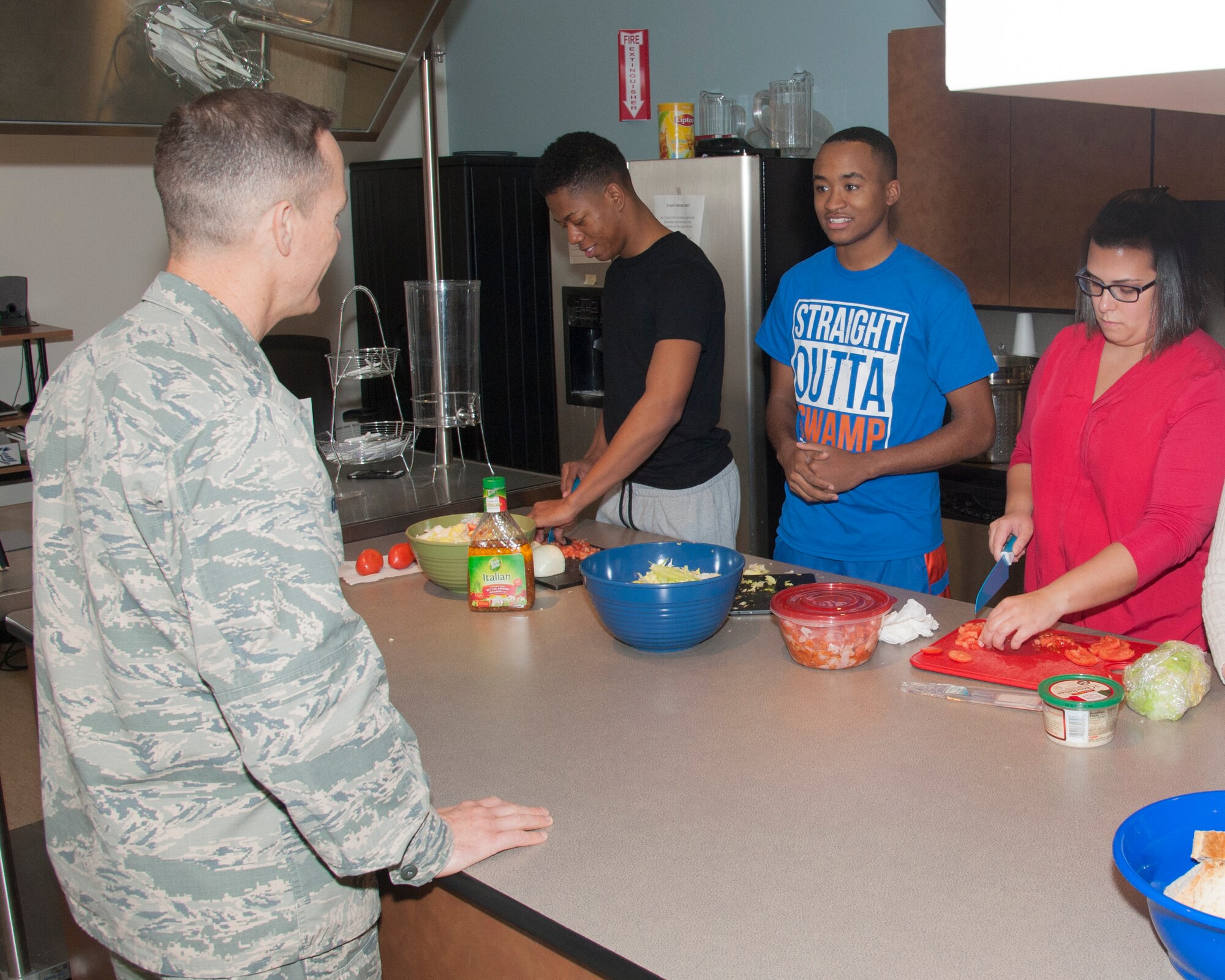 Col. Kevin Gordon, 436th Airlift Wing vice commander, talks with Airman 1st Class Garrisson Warner, 436th Logistics Readiness Squadron material handler specialist, during Dorm to Gourm Jan. 5, 2016, at the Health Promotion Flight kitchen in the Fitness Center on Dover Air Force Base, Del. The purpose of the course is to teach Airmen, who live in the dorms, how to cook healthy meals for themselves. (U.S. Air Force photo/Staff Sgt. Jared Duhon)