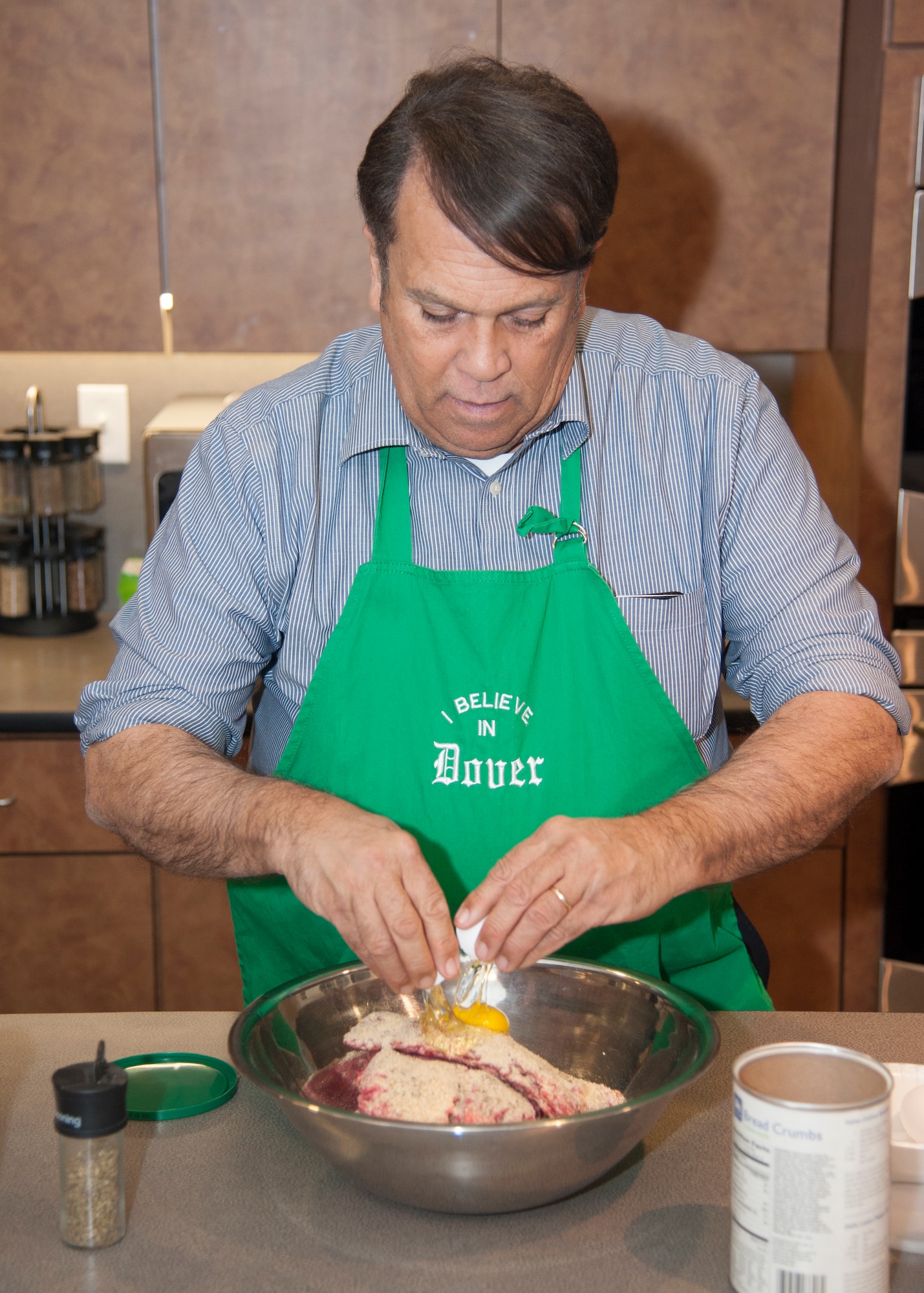Robin Christiansen, Mayor of Dover, prepares a meatball mixture during Dorm to Gourm Jan. 5, 2016, at the Health Promotion Flight kitchen in the Fitness Center on Dover Air Force Base, Del. The mixture was sausage with hamburger meat and was added to spaghetti being made that night. (U.S. Air Force photo/Staff Sgt. Jared Duhon)