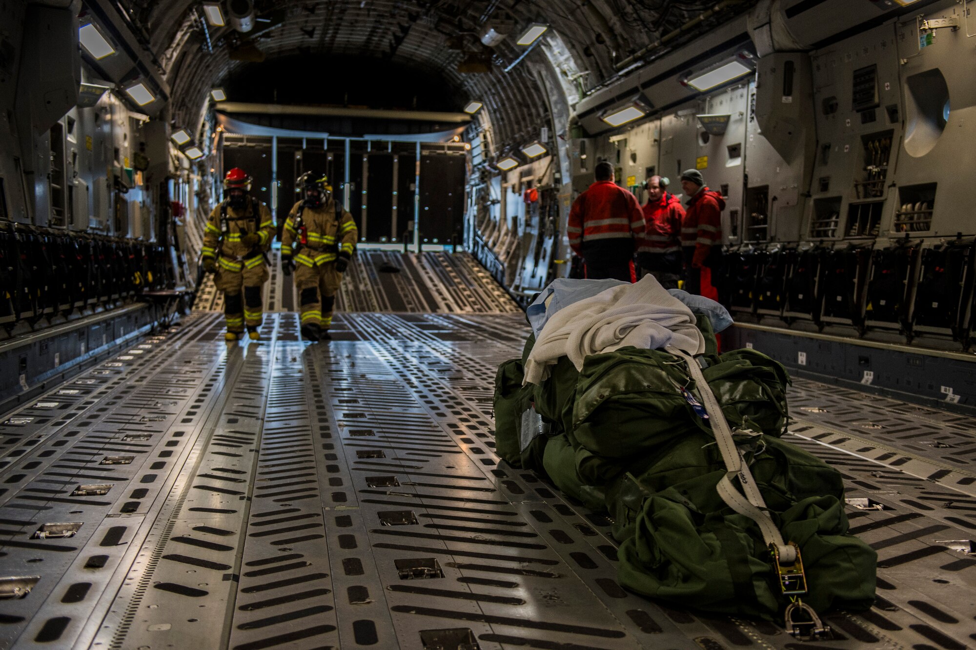 Emergency response Airmen inspect the inside a C-17 Globemaster III aircraft, assigned to the 62nd Airlift Wing at Joint Base Lewis-McChord, Wash., during training at Spangdahlem Air Base, Germany, Jan. 12, 2016. The exercise incorporated a range of base agencies including the fire department, security forces, airfield operations and explosive ordnance disposal units. (U.S. Air Force photo by Airman 1st Class Luke Kitterman/Released)