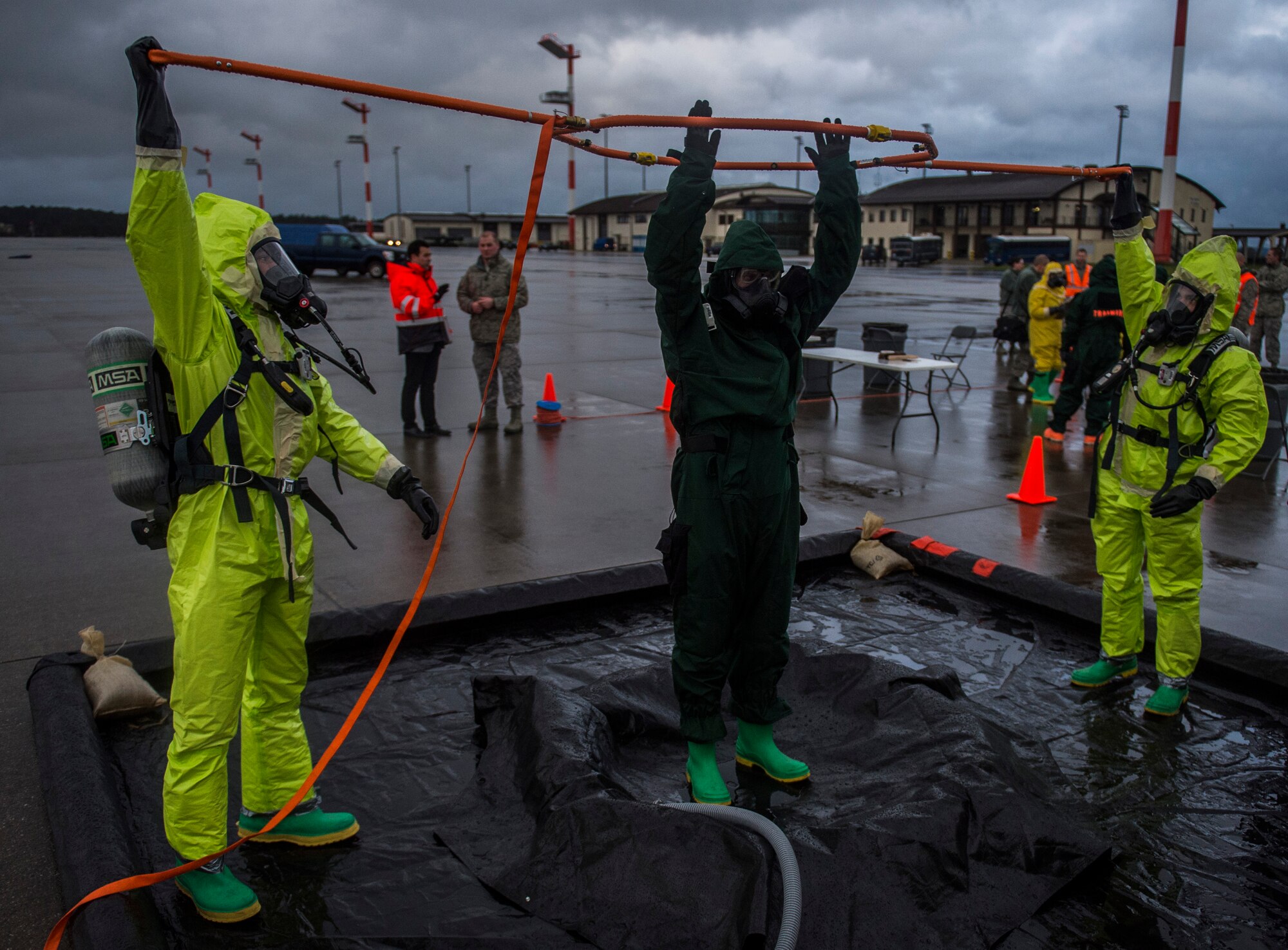 Emergency response Airmen perform a mock cleansing during training on the flightline at Spangdahlem Air Base, Germany, Jan. 12, 2016. The exercise displayed the wing’s ability to respond to a variety of contingencies and mitigate potential hindrances on the base’s mission. (U.S. Air Force photo by Airman 1st Class Luke Kitterman/Released)