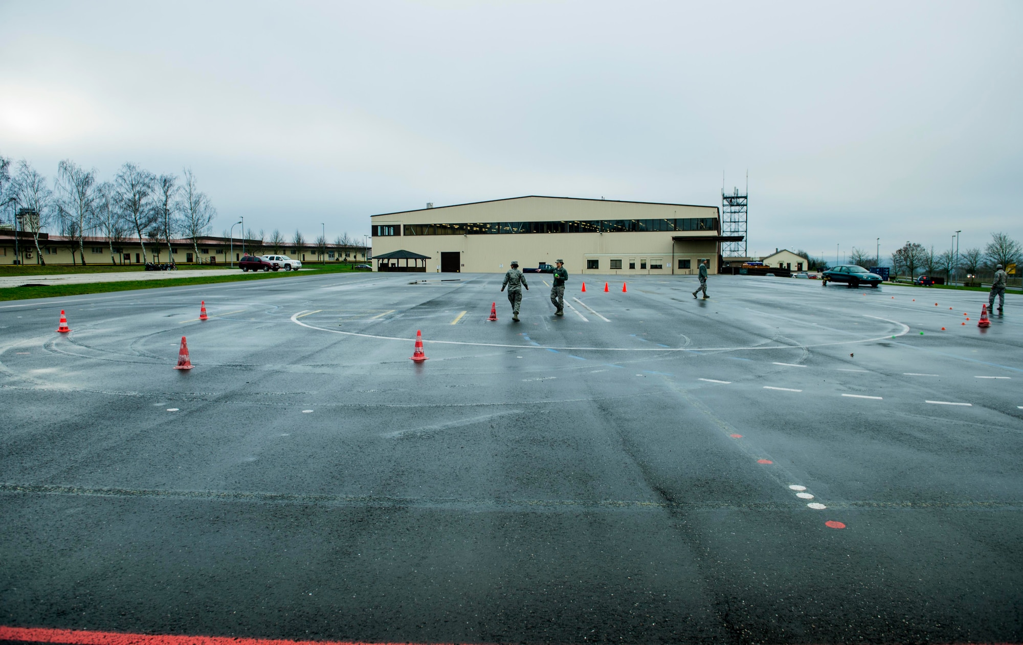 The 52nd Fighter Wing Safety team set up traffic cones at the Saber Driving Course before a training session at the driving course at Spangdahlem Air Base, Germany, Jan. 8, 2016. The course utilizes traffic cones and special markers at designated points that trainees must navigate under simulated road conditions. (U.S. Air Force photo by Airman 1st Class Timothy Kim/Released)