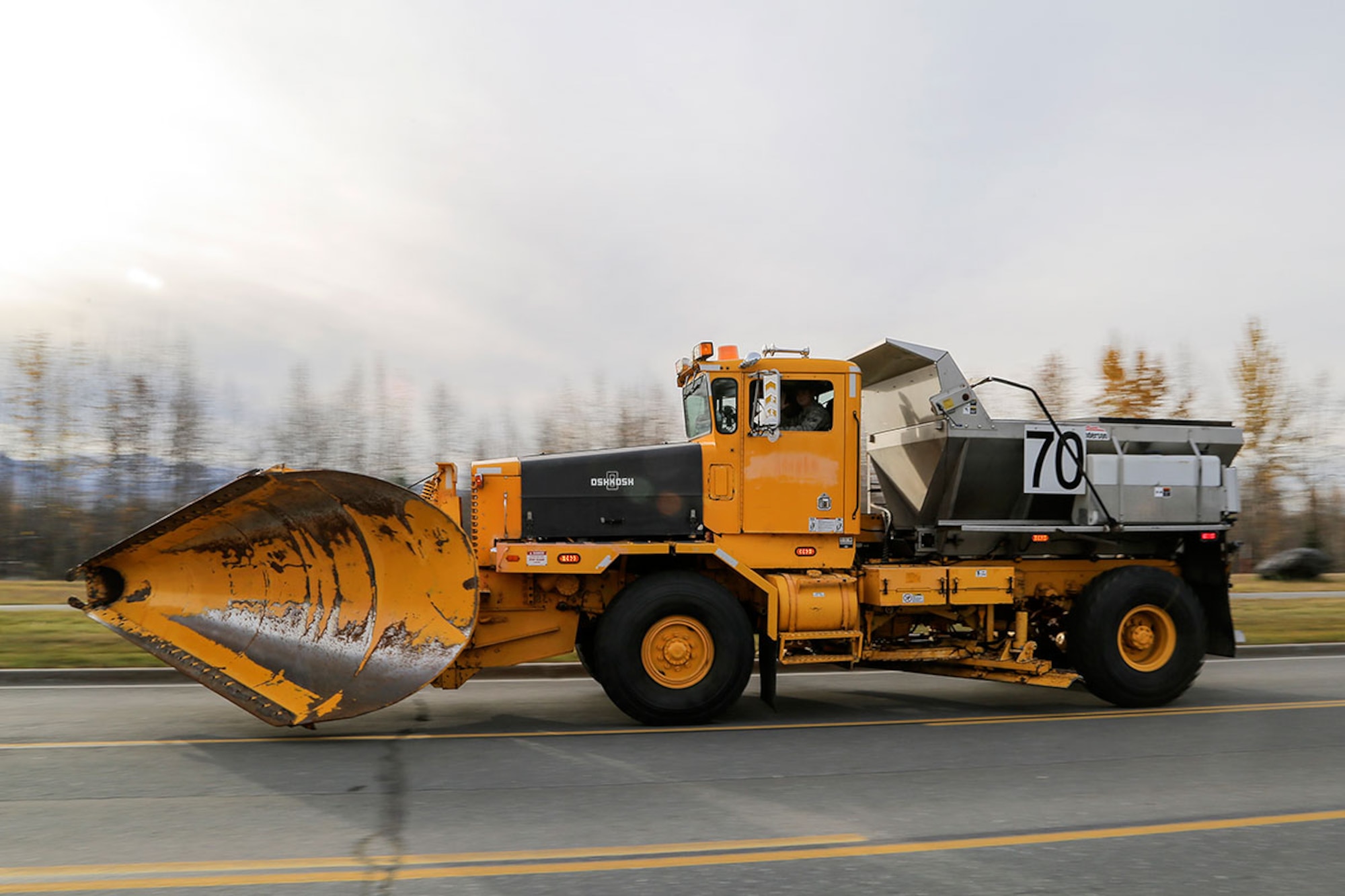 A member of the 773d Civil Engineering Squadron operates snow removal equipment during the annual Snow & Ice Parade on Joint Base Elmendorf-Richardson, Alaska, Oct. 9, 2015. Regardless of the amount of snowfall, the snow barn works to keep the runways and roads clear and ready for emergency missions 24/7. (U.S. Air Force photo by Alejandro Pena)