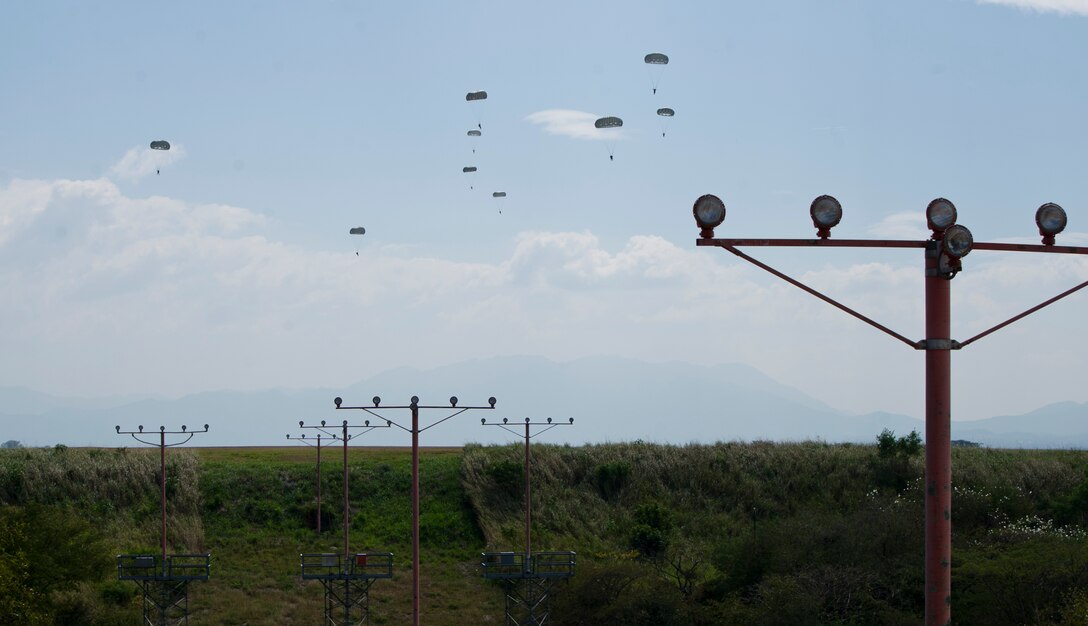 U.S. Army Soldiers with the Special Operations Command South (Forward) 7310 and Honduran soldiers with the 2nd Honduran Airborne Brigade complete a static-line training jump Jan. 11, 2016 at Soto Cano Air Base, Honduras to remain current on their jump requirements. The Soldiers from the two countries often train together to share best practices and form interpersonal bonds. (U.S. Air Force photo by Capt. Christopher Mesnard/Released)